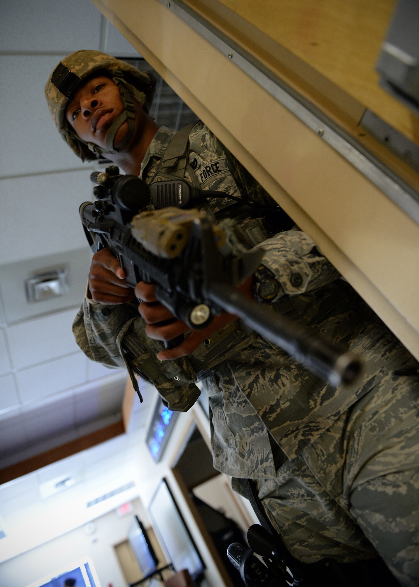 Senior Airman Veon Selman, 354th Security Forces Squadron response force leader, responds to a simulated active shooter during an exercise Sept. 10, 2013, Eielson Air Force Base, Alaska. Emergency responders quickly apprehended the suspect during the scenario, which is part of the Pacific Air Forces Readiness Focused Consolidated Unit Inspection to evaluate the base on readiness and compliance with operational instructions. (U.S. Air Force photo by Senior Airman Shawn Nickel/Released)