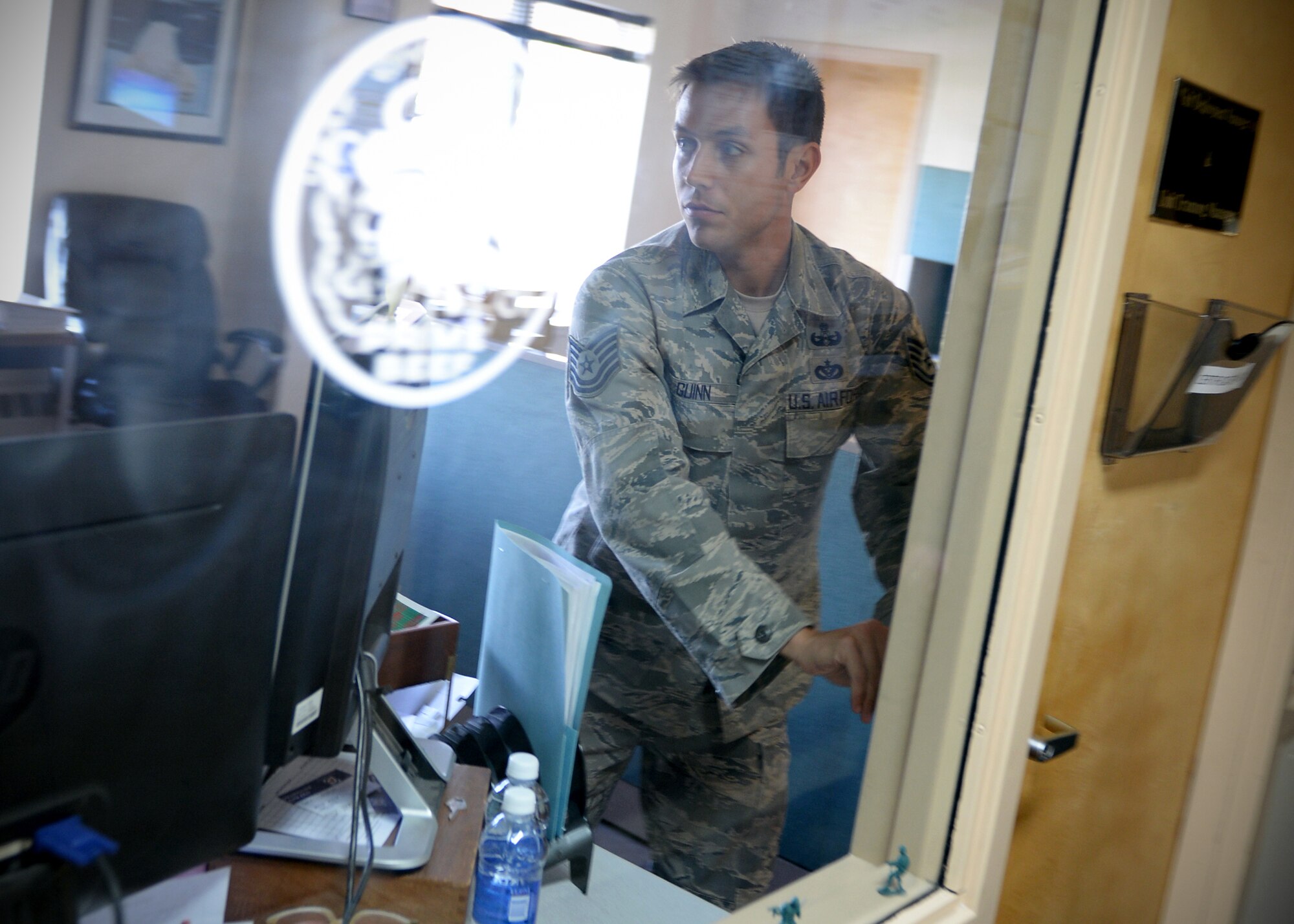 Tech. Sgt. Kenneth Guinn, 354th Civil Engineer Squadron explosive ordinance disposal technician, locks the door before taking cover during an active shooter exercise Sept. 10, 2013, Eielson Air Force Base, Alaska. The exercise is part of the Pacific Air Forces Readiness Focused Consolidated Unit Inspection, which evaluates the base on readiness and compliance with operational instructions. (U.S. Air Force photo by Senior Airman Shawn Nickel/Released)