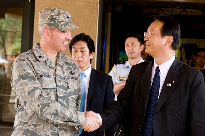 Brig. Gen. Stephen Whiting, U.S. Air Force Warfare Center vice commander, shakes hands with Akinori Eto, Japanese senior vice-minister of defense, during his visit Sept. 11, 2013, at Nellis Air Force Base, Nev. Eto's visit included a mission over view of the U.S. Air Force Warfare Center, briefings about F-22 Raptor and F-35 Lighting II aircraft and the opportunity to observe aircrafts taking off. (U.S. Air Force photo by Senior Airman Matthew Lancaster)