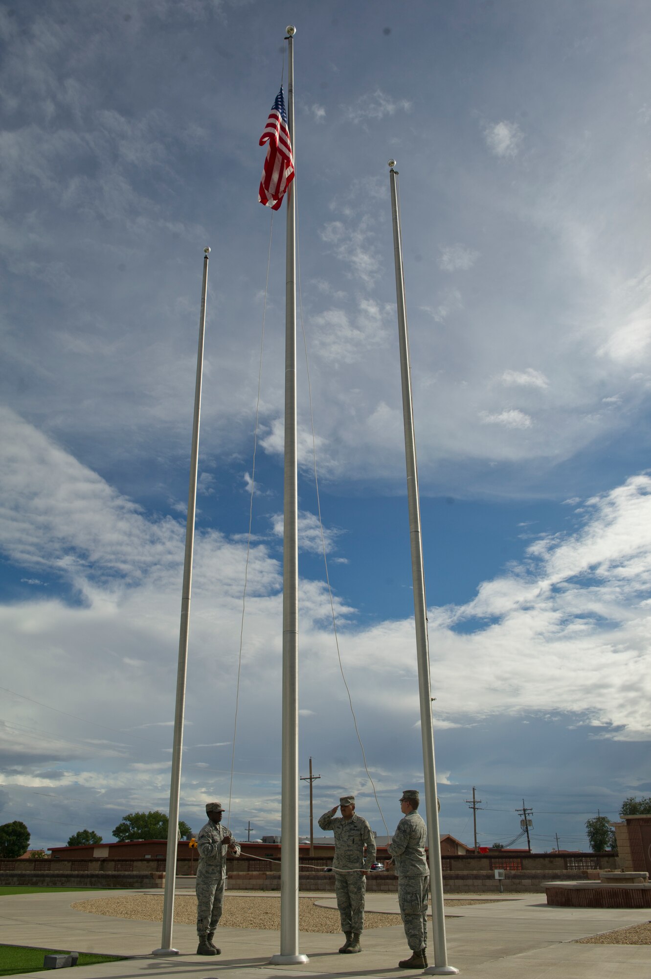 Members of Team Holloman Steel Talons Honor Guard prepare to lower the flag for the September 11th Remembrance event at Holloman Air Force Base, N.M., Sept. 11. . Members of Team Holloman honor the 16,428 members who have deployed from the 49th Wing since the Sept. 11, 2001 terrorist attacks. Col. James Thompson, 49th Wing vice commander, spoke of Holloman’s post-9/11 contributions during the ceremony, which took place at Heritage Park. (U.S. Air Force photo by Airman 1st Class Chase Cannon/Released)