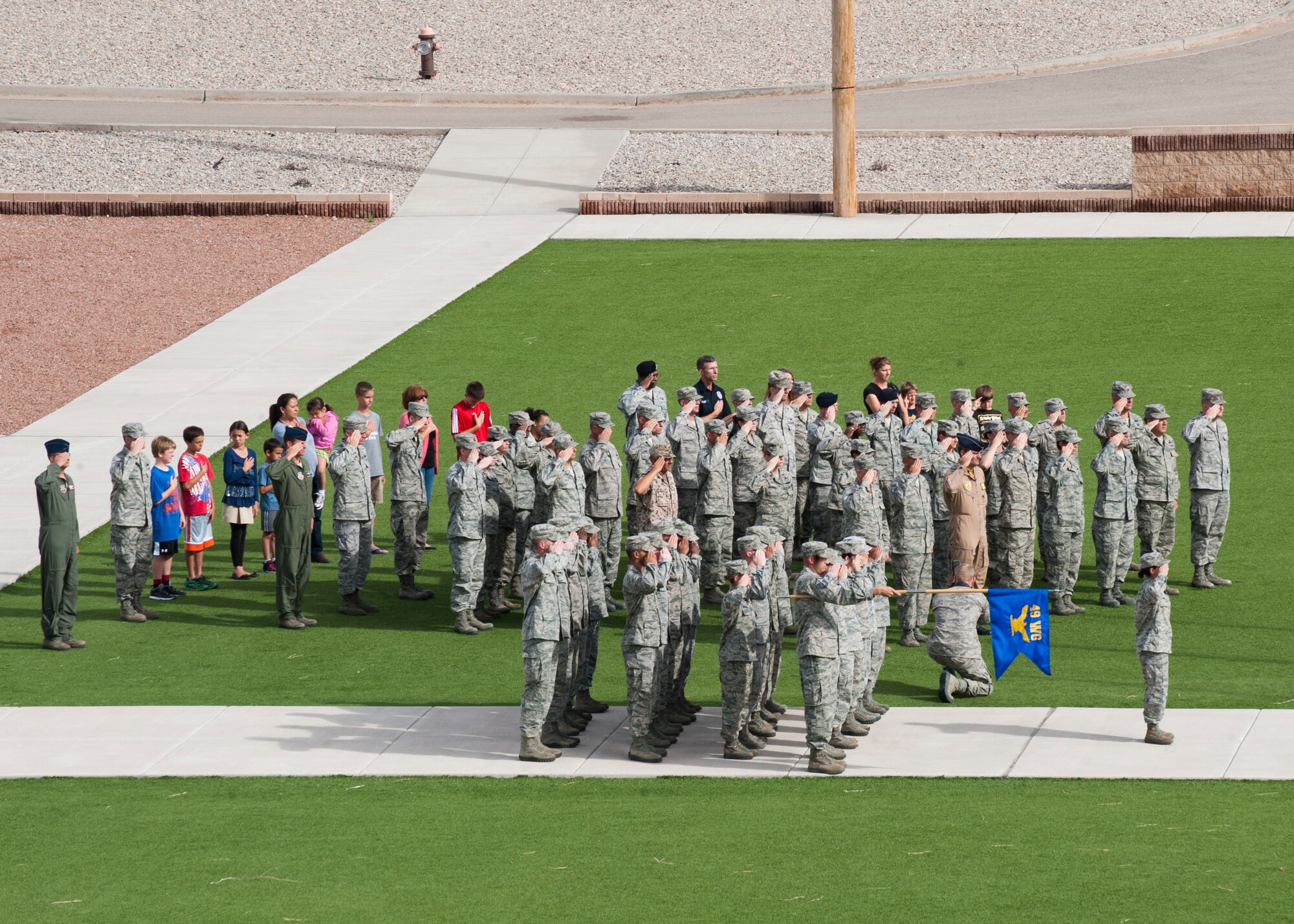 Members of Team Holloman salute the American flag during the September 11th Remembrance event at Holloman Air Force Base, N.M., Sept. 11.During the ceremony, retreat played, honoring the 16,428 members who have deployed from the 49th Wing since the Sept. 11, 2001 terrorist attacks. Col. James Thompson, 49th Wing vice commander, spoke of Holloman’s post-9/11 contributions during the ceremony, which took place at Heritage Park. (U.S. Air Force photo by Airman 1st Class Daniel E. Liddicoet/Released)