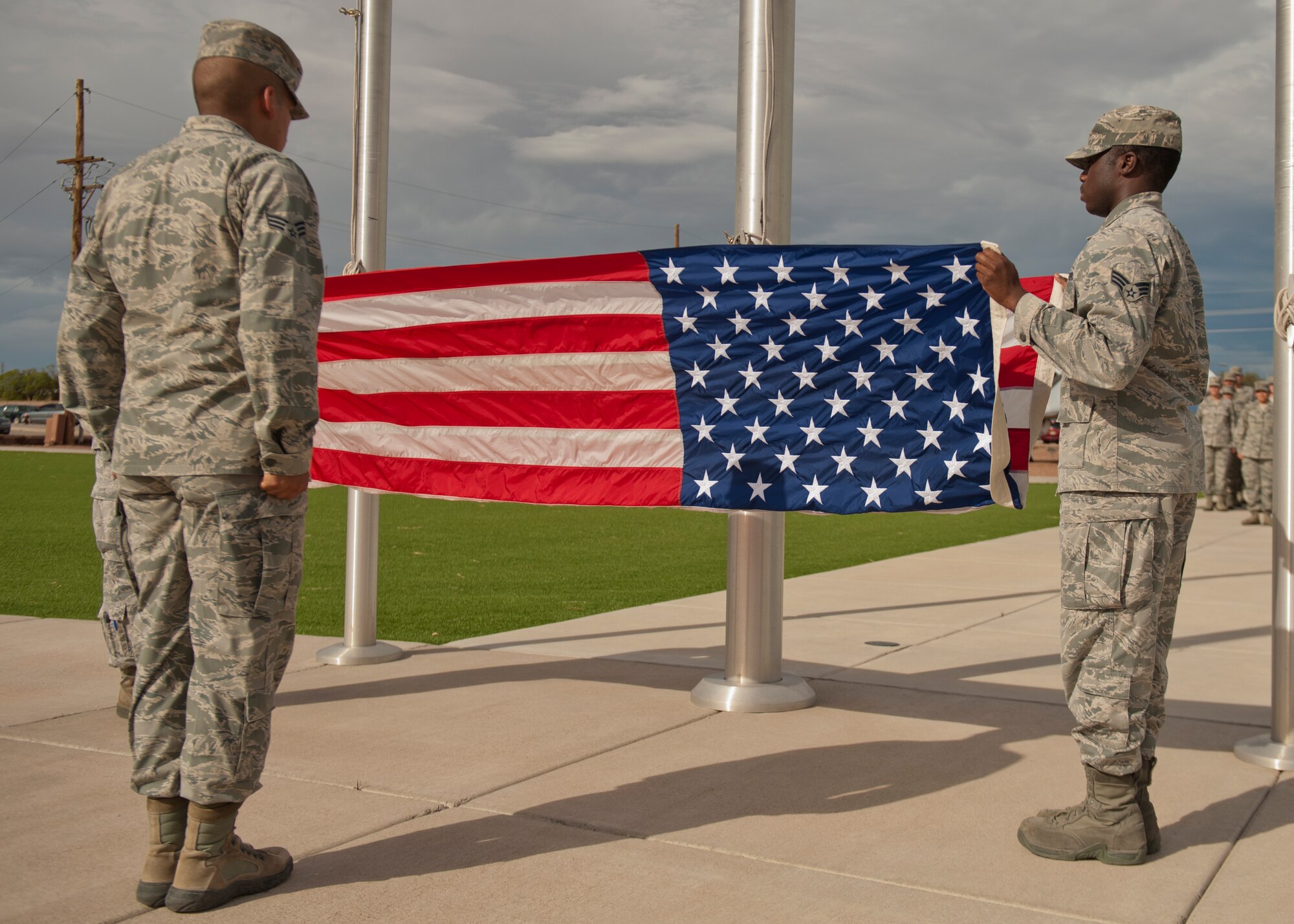 Members of the Holloman Air Force Base Steel Talons Honor Guard lower and fold the flag during the September 11th Remembrance event at Holloman Air Force Base, N.M., Sept. 11. Members of Team Holloman salute the American flag as retreat plays, honoring the 16,428 members who have deployed from the 49th Wing since the Sept. 11, 2001 terrorist attacks. Col. James Thompson, 49th Wing vice commander, spoke of Holloman’s post-9/11 contributions during the ceremony, which took place at Heritage Park. (U.S. Air Force photo by Airman 1st Class Aaron Montoya/Released)