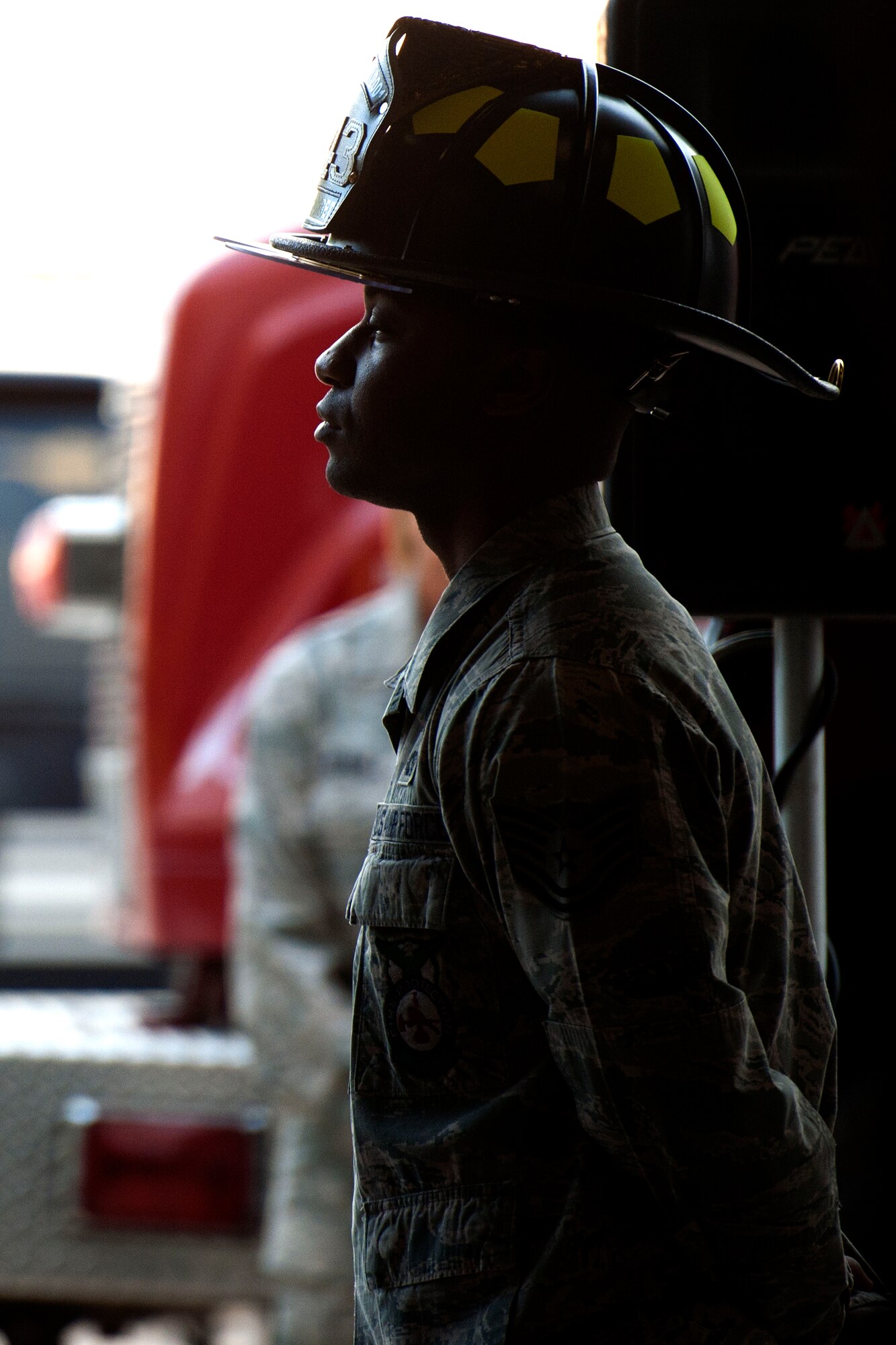 ALTUS AIR FORCE BASE, Okla. – Tech. Sgt. Allen Harris, 97th Civil Engineer Squadron firefighter, presents the colors during a 9/11 remembrance ceremony Sept. 11 at the base fire department. Members of Altus AFB gathered to remember emergency responders who lost their lives during the Sept. 11, 2001 tragedy. (U.S. Air Force Photo by Senior Airman Jesse Lopez / Released)