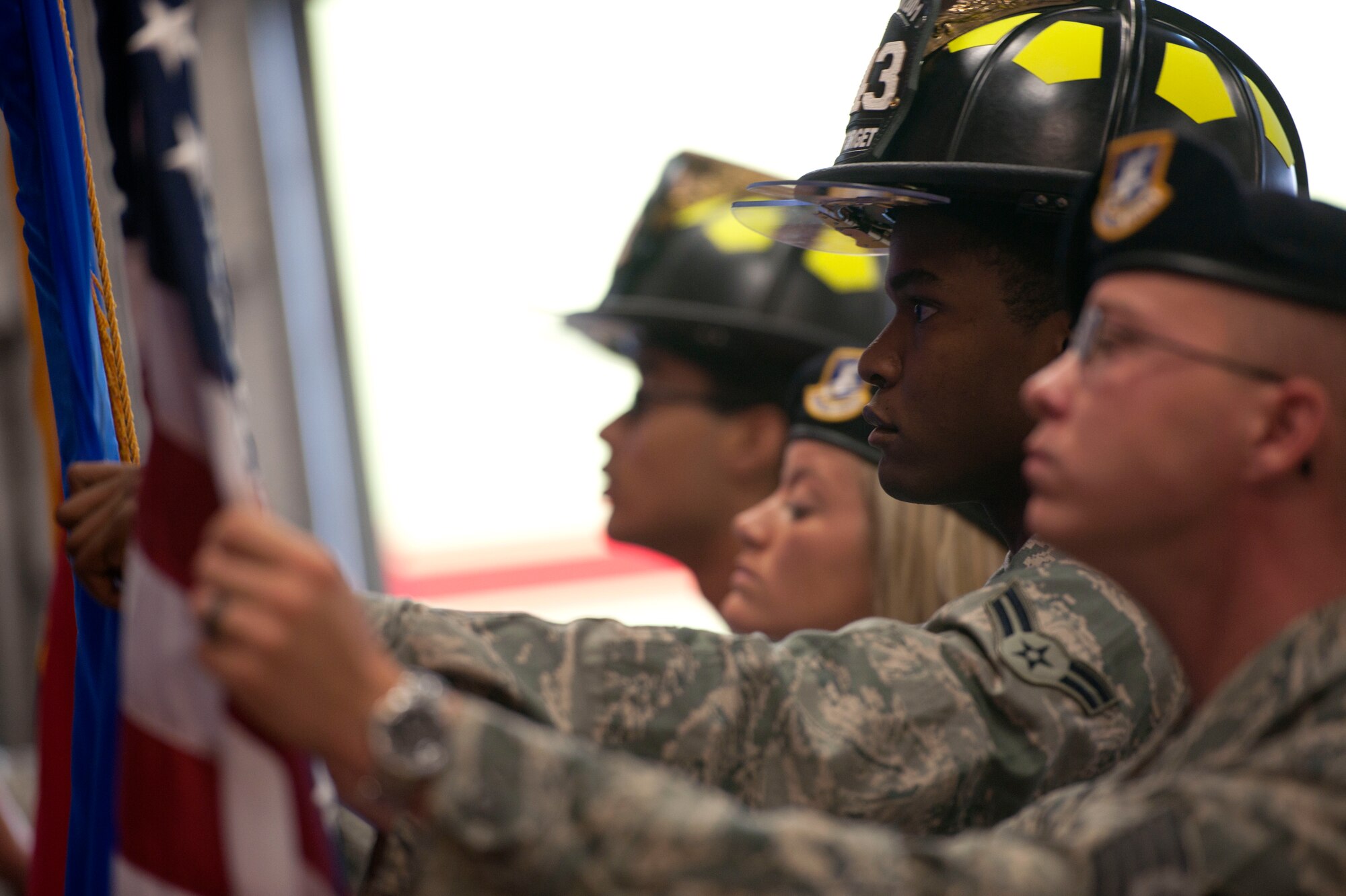 ALTUS AIR FORCE BASE, Okla. -- Members of the 97th Security Forces Squadron and the 97th Civil Engineer Squadron post the colors during a 9/11 remembrance ceremony Sept. 11 at the base fire department. The ceremony honored the 343 New York City fallen firefighters and the 23 police officers who lost their lives in the events on Sept. 11, 2001. (U.S. Air Force Photo by Senior Airman Jesse Lopez / Released)