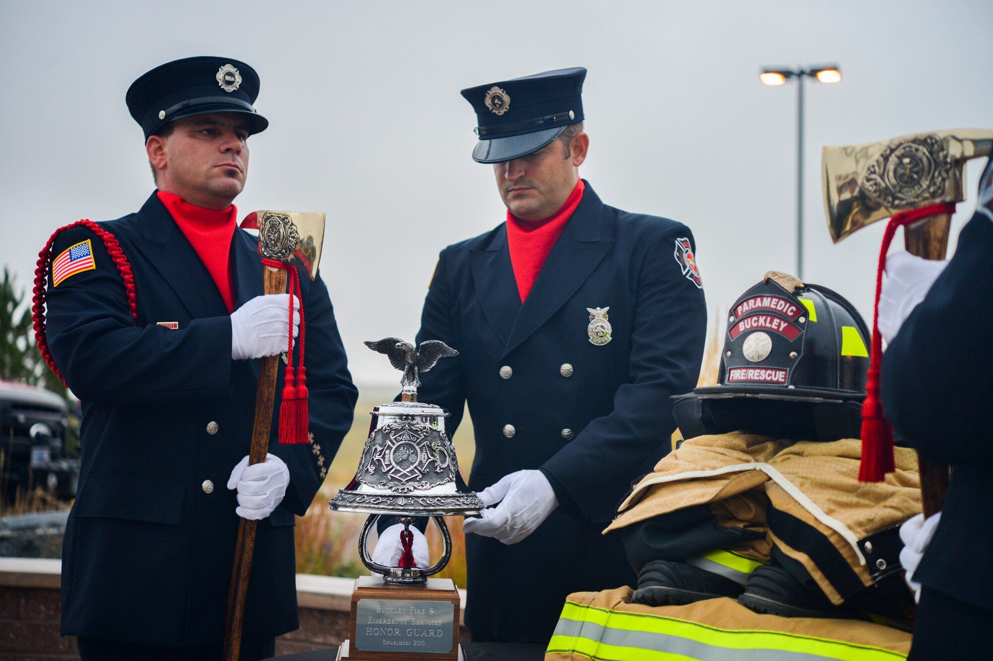 An Aurora Fire Department Honor Guard member rings a ceremonial bell in observance of Patriot Day and National Day of Remembrance ceremony Sept. 11, 2013, at the 460th Space Wing headquarters building on Buckley Air Force Base, Colo. The ringing of the bell memorialized the firefighters who died responding to the 9/11 terrorist attacks in New York City. (U.S. Air Force photo by Staff Sgt. Paul Labbe/Released)