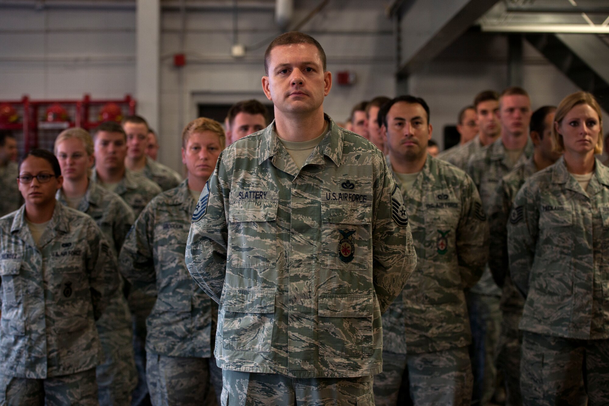 ALTUS AIR FORCE BASE, Okla. -- Members of the 97th Security Forces Squadron and the 97th Civil Engineer Squadron stand in formation during a 9/11 remembrance ceremony Sept. 11 at the base fire department. The ceremony honored the 343 fallen New York City firefighters and the 23 police officers who lost their lives in the events on 11 Sept. 2001. (U.S. Air Force Photo by Senior Airman Jesse Lopez / Released)