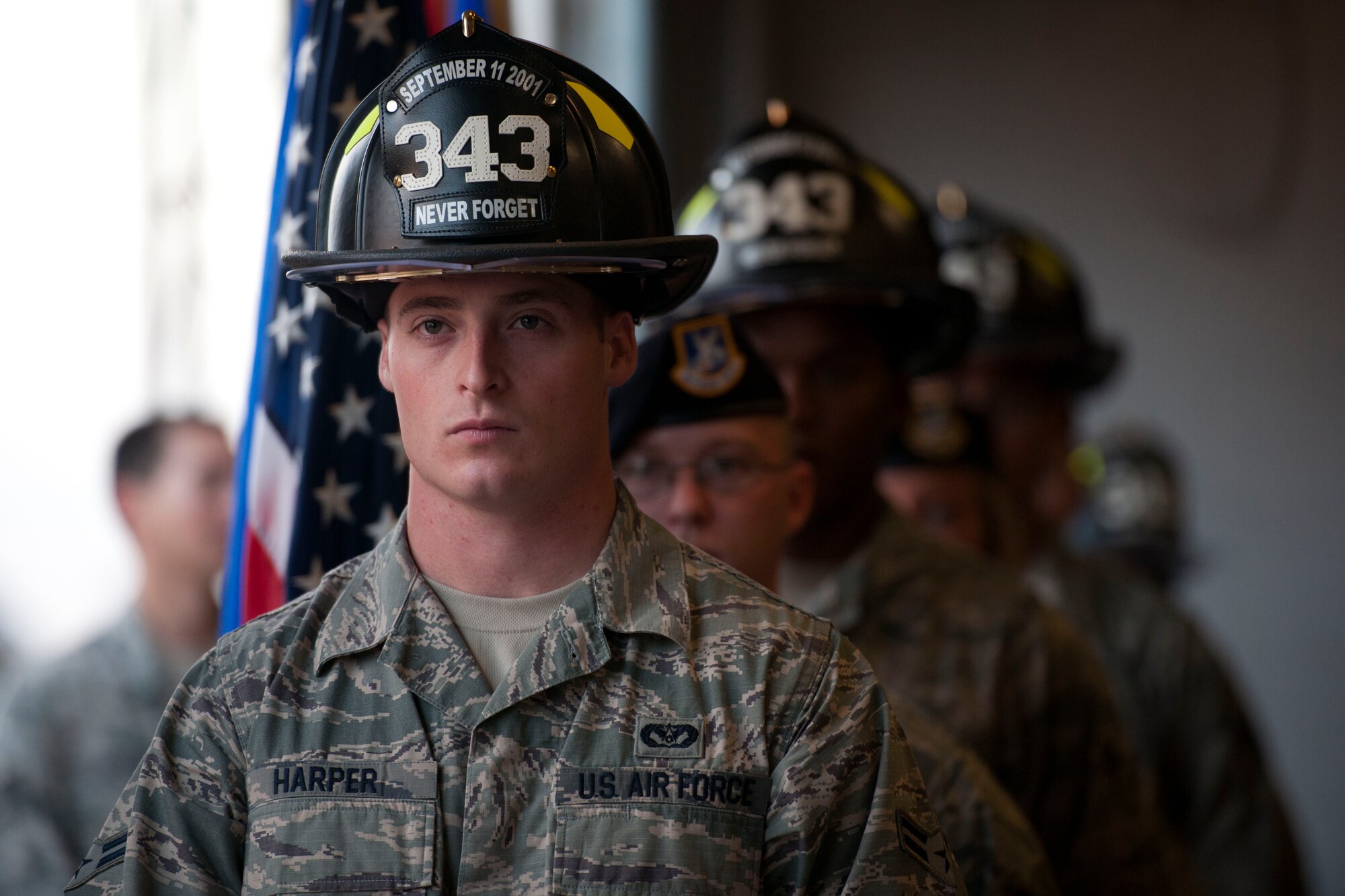 ALTUS AIR FORCE BASE, Okla. -- Members of the 97th Security Forces Squadron and the 97th Civil Engineer Squadron present the colors during a 9/11 remembrance ceremony Sept. 11 at the base fire department. The ceremony was held in honor of those who lost their lives Sept. 11, 2001. (U.S. Air Force Photo by Senior Airman Jesse Lopez / Released)