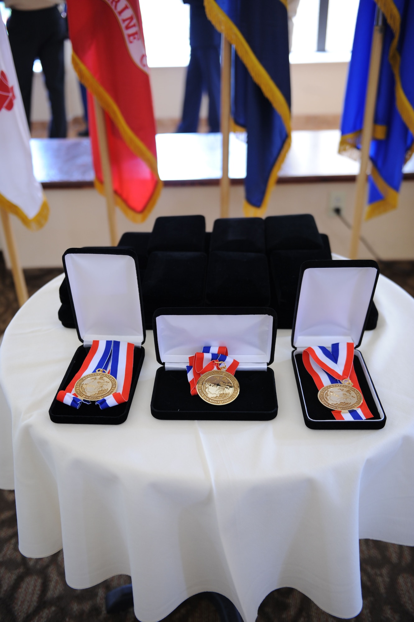 The medallions for the World War II Veterans Medallion Ceremony sit on a table at the front of the dining hall at Silver Springs Senior Living Community in Green Valley, Ariz., Sept. 7, 2013. The event was a joint effort between local Airmen, sailors, soldiers, Marines and Silver Springs employees. (U.S. Air Force photo by Airman 1st Class Saphfire Cook/Released) 