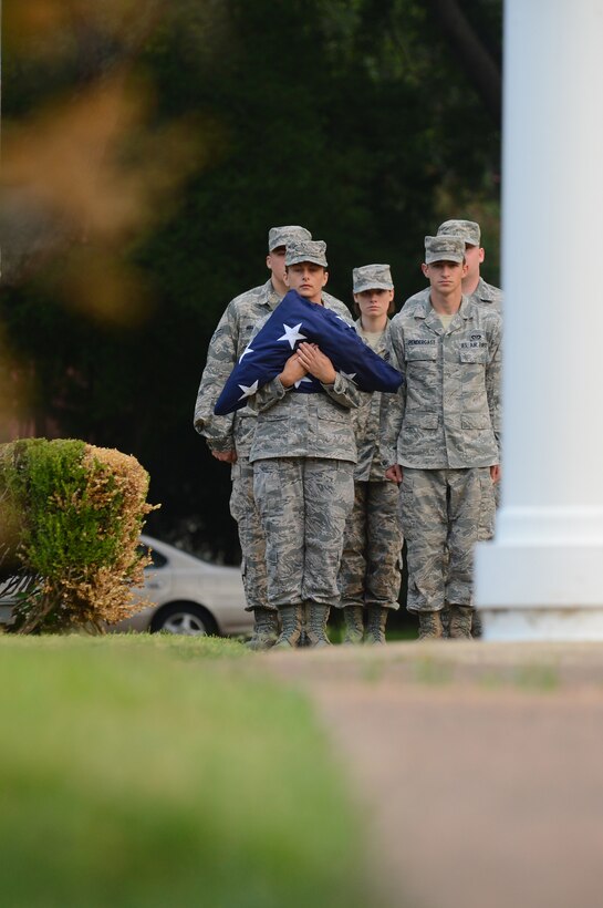Airmen from Airman Leadership School prepare to raise the flag for reveille on Barksdale Air Force Base, La., Sept. 11, 2013. Airmen, civilians, retirees and dependents gathered in front of the base flag pole to remember the events that took place 12 years ago. (U.S. Air Force photo/Senior Airman Micaiah Anthony)