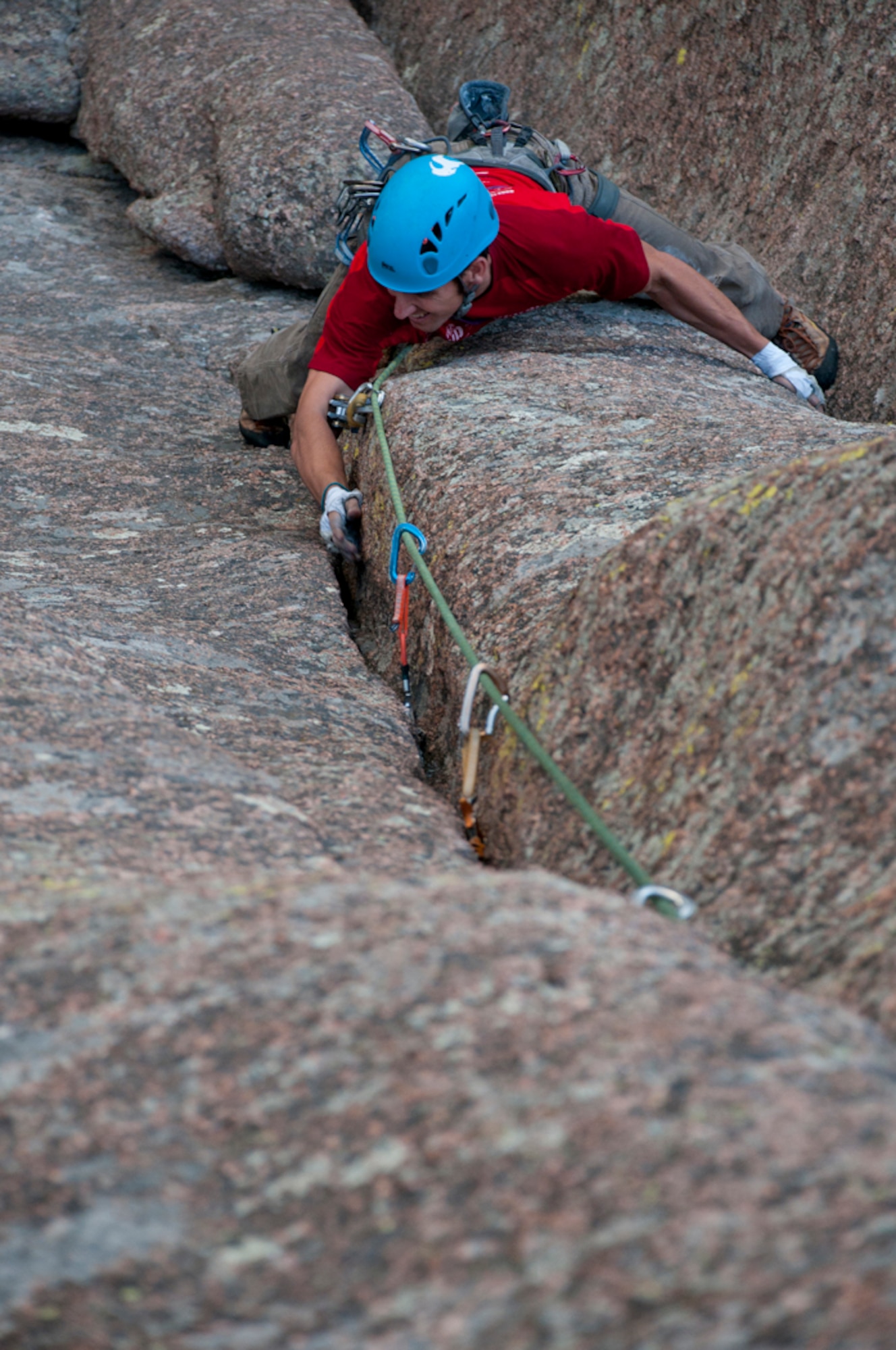 Capt. Austin Winner, 90th Operations Group evaluator, clings to a column of rock as he ascends a rock face at Vedauwoo, Wyo., Aug. 28, 2013. (U.S. Air Force photo by Airman 1st Class Jason Wiese)