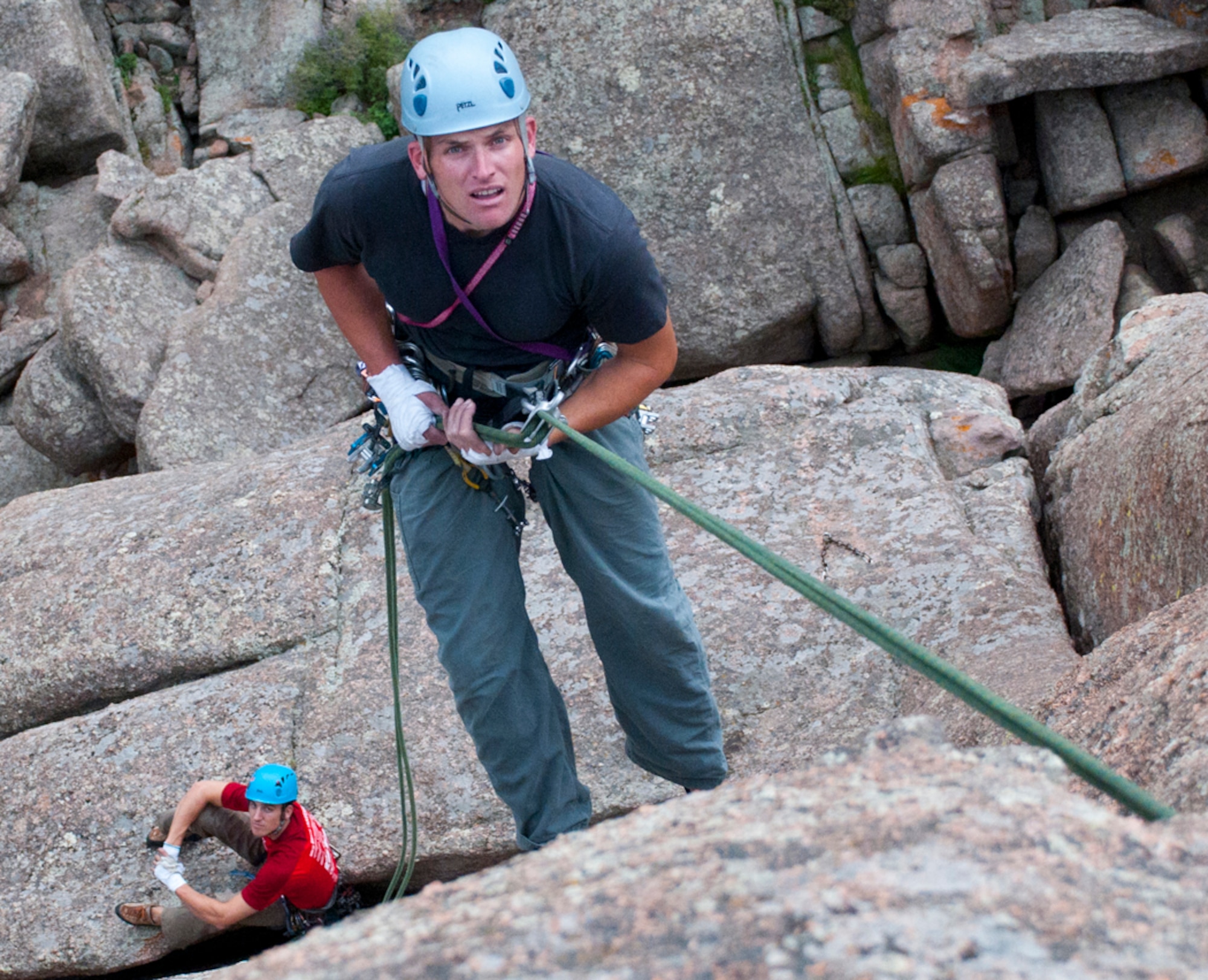 Capt. Jeff Rees, 321st Missile Squadron flight commander, rappels down a cliff Aug. 28, 2013, at Vedauwoo, a formation of rocks and boulders within Medicine Bow-Routt National Forest in Wyoming. His climbing partner, Capt. Austin Winner, 90th Operations Group evaluator, waits for him on a rock ledge below. (U.S. Air Force photo by Airman 1st Class Jason Wiese)