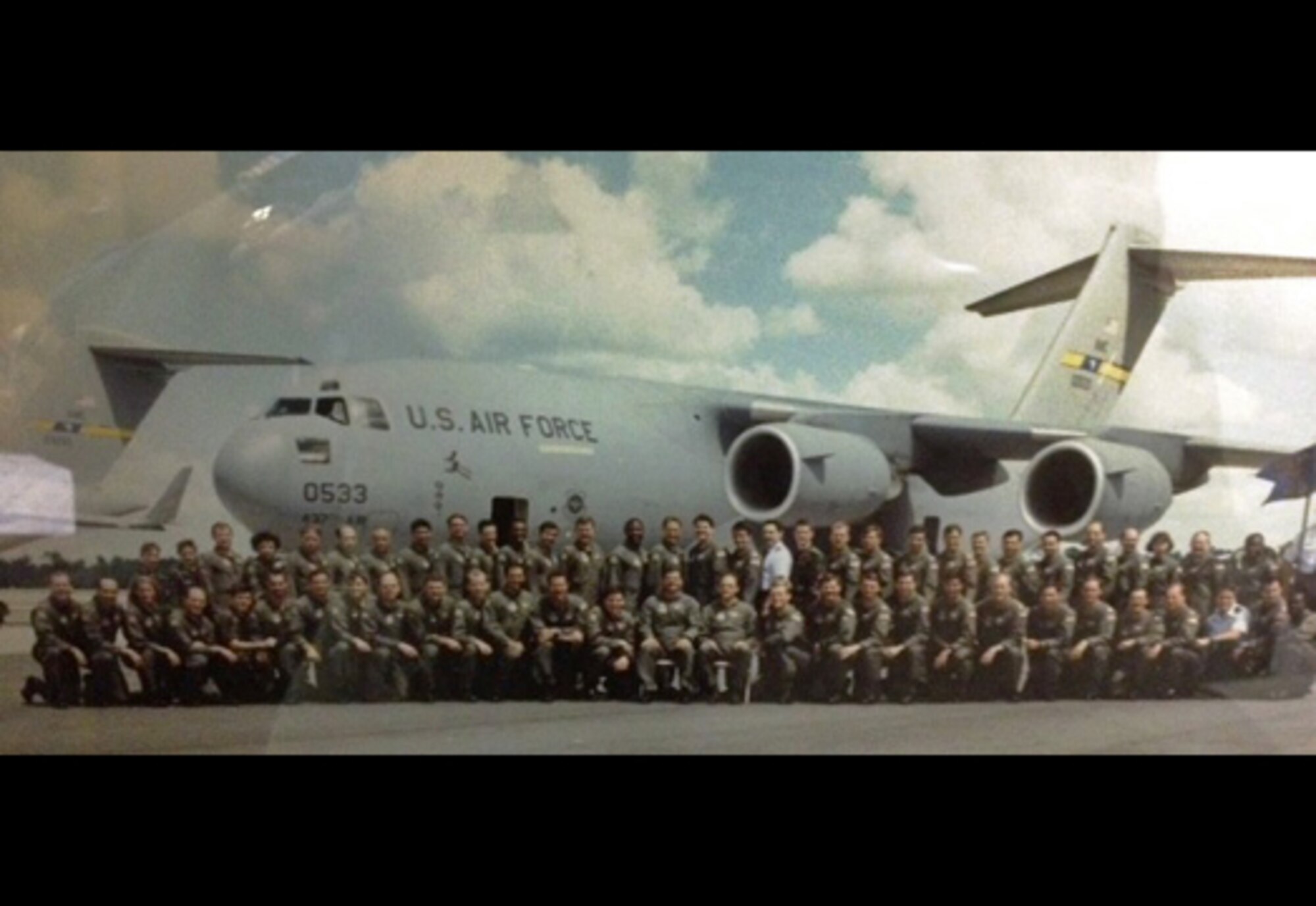 Reserve members of the original C-17 cadre. pose for a photo in front of the the Air Force's first C-17. (Courtesy Photo)