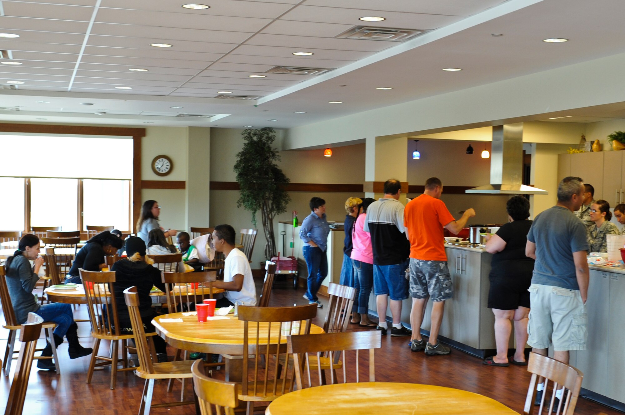 Ronald McDonald House residents partake in tacos and baked potatoes Sept. 10, 2013, at the Ronald McDonald House in Aurora, Colo. Fourteen Team Buckley members prepared tacos and baked potatoes for families staying at the Ronald McDonald House. The organization offers a home away from home for families needing to be near their seriously ill or injured children while they're being treated at nearby hospitals. (U.S. Air Force photo by Airman 1st Class Riley Johnson/Released)