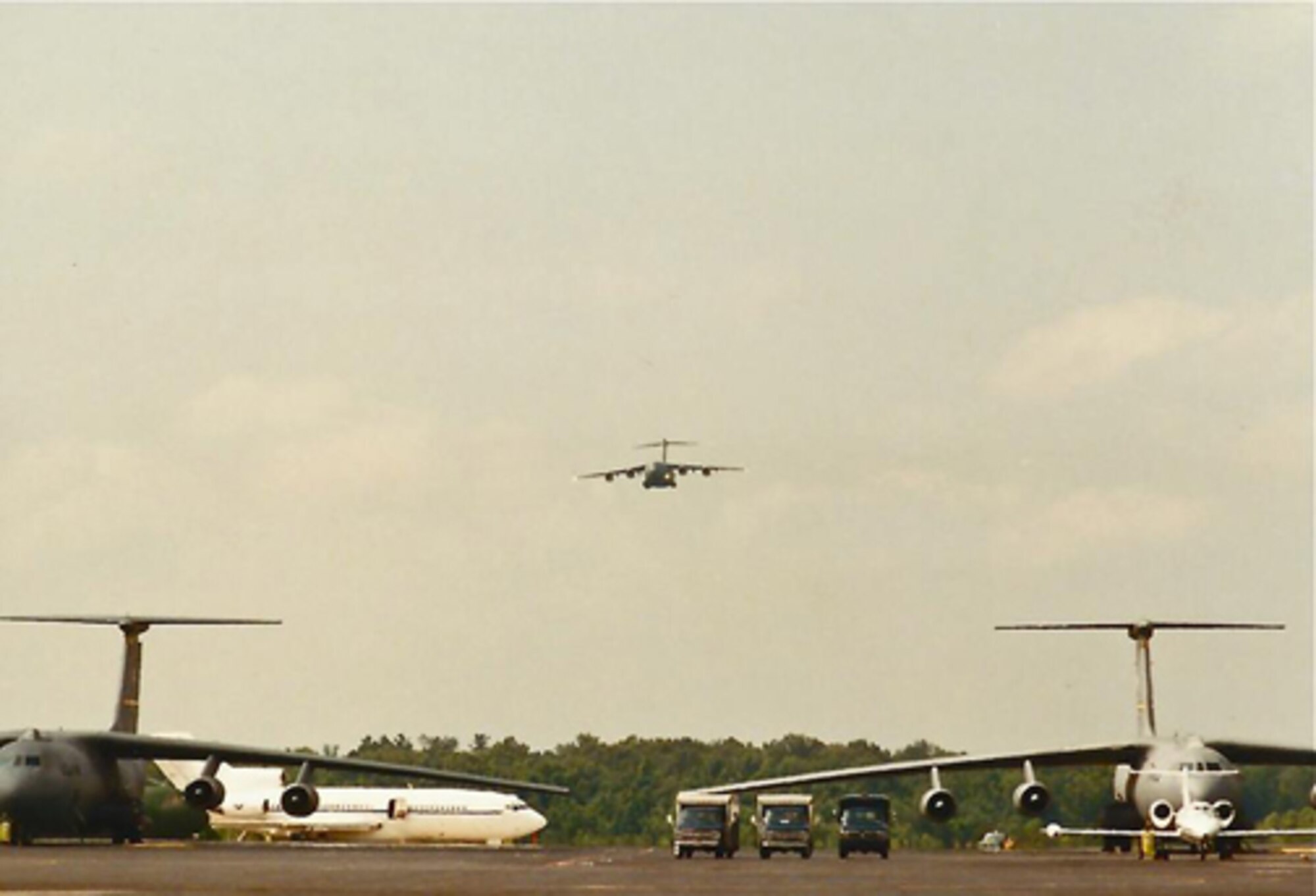 The Air Force's first C-17 arrives at Charleston Air Force Base, S.C.  June 14, 1993 approaches the runway amid a sea of C-141 Starlifthers. Now 20 years later the final Air Force C-17 will be arriving from the Boeing C-17 factory Sept. 12, 2013. (Courtesy Photo)