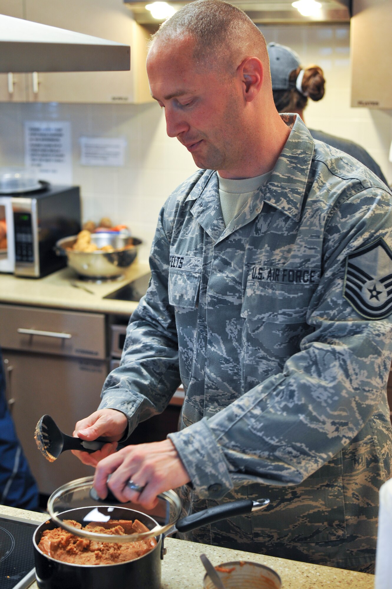 Master Sgt. James Felts, 460th Space Wing Inspector General, prepares beans for tacos Sept. 10, 2013, at the Ronald McDonald House in Aurora, Colo. Fourteen Team Buckley members prepared tacos and baked potatoes for families staying at the Ronald McDonald House. The organization offers a home away from home for families needing to be near their seriously ill or injured children while they're being treated at nearby hospitals. (U.S. Air Force photo by Airman 1st Class Riley Johnson/Released)