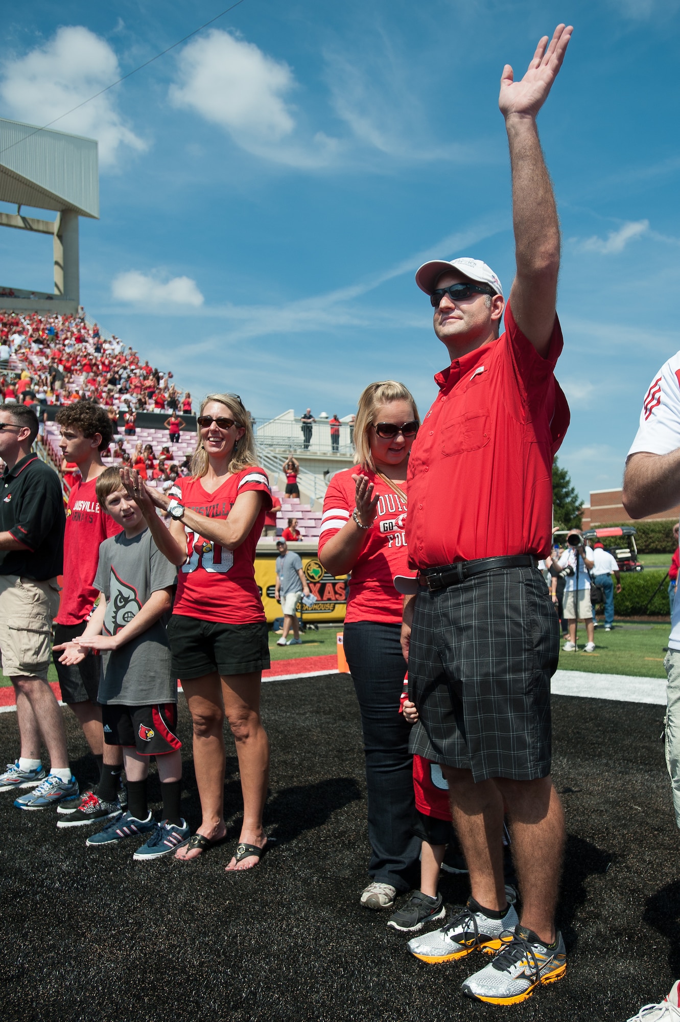 Master Sgt. Robert Fernandez, a combat controller in Kentucky Air National Guard’s 123rd Special Tactics Squadron, is honored for exceptional service Sept. 7, 2013, during Military Appreciation Day events held as part of the University of Louisville-Eastern Kentucky University football game at Papa John’s Cardinal Stadium in Louisville, Ky. A former U of L football player, Fernandez has deployed multiple times to Iraq and Afghanistan, where he directed numerous air strikes on enemy insurgents, and to the Gulf Coast region of the United States where he supported massive rescue operations following Hurricanes Katrina and Rita. (U.S. Air National Guard photo by Maj. Dale Greer)