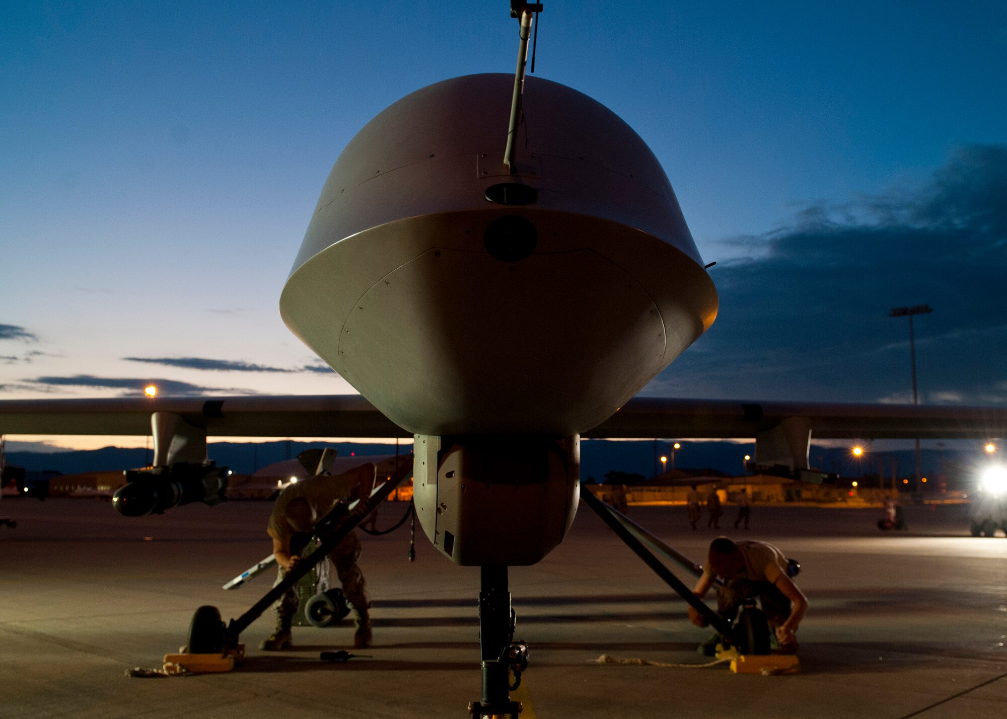 Airmen with the 849th Aircraft Maintenance Squadron set wheel chalks on an MQ-1 Predator at Holloman Air Force Base, N.M., Sept. 3. The Airmen of the 849th AMXS maintain 24-hour operations to ensure that MQ-1 Predators and MQ-9 Reaper Remotely Piloted Aircraft are always available for training. (U.S. Air Force photo by Airman 1st Class Daniel E. Liddicoet/Released)