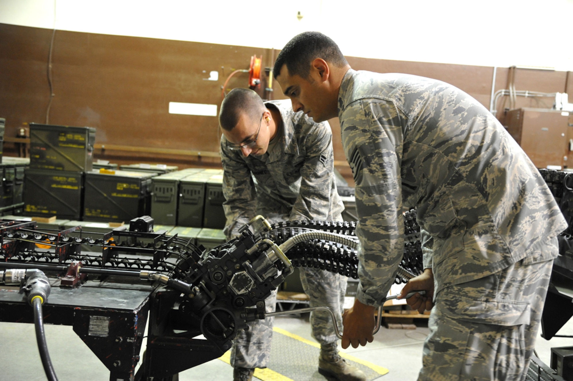 Staff Sgt. Christopher Lawson and Airman 1st Class Dustin Mahonec, both of the 3rd Munitions Squadron, assemble a universal ammunition loading system in the Conventional Maintenance shop on Joint Base Elmendorf-Richardson August 21. Conventional Maintenance is one of the many sections of 3rd MUNS that contributes to the loading of ammunition onto F-22 aircraft. (U.S. Air Force photo by Staff Sgt. Blake Mize/released)