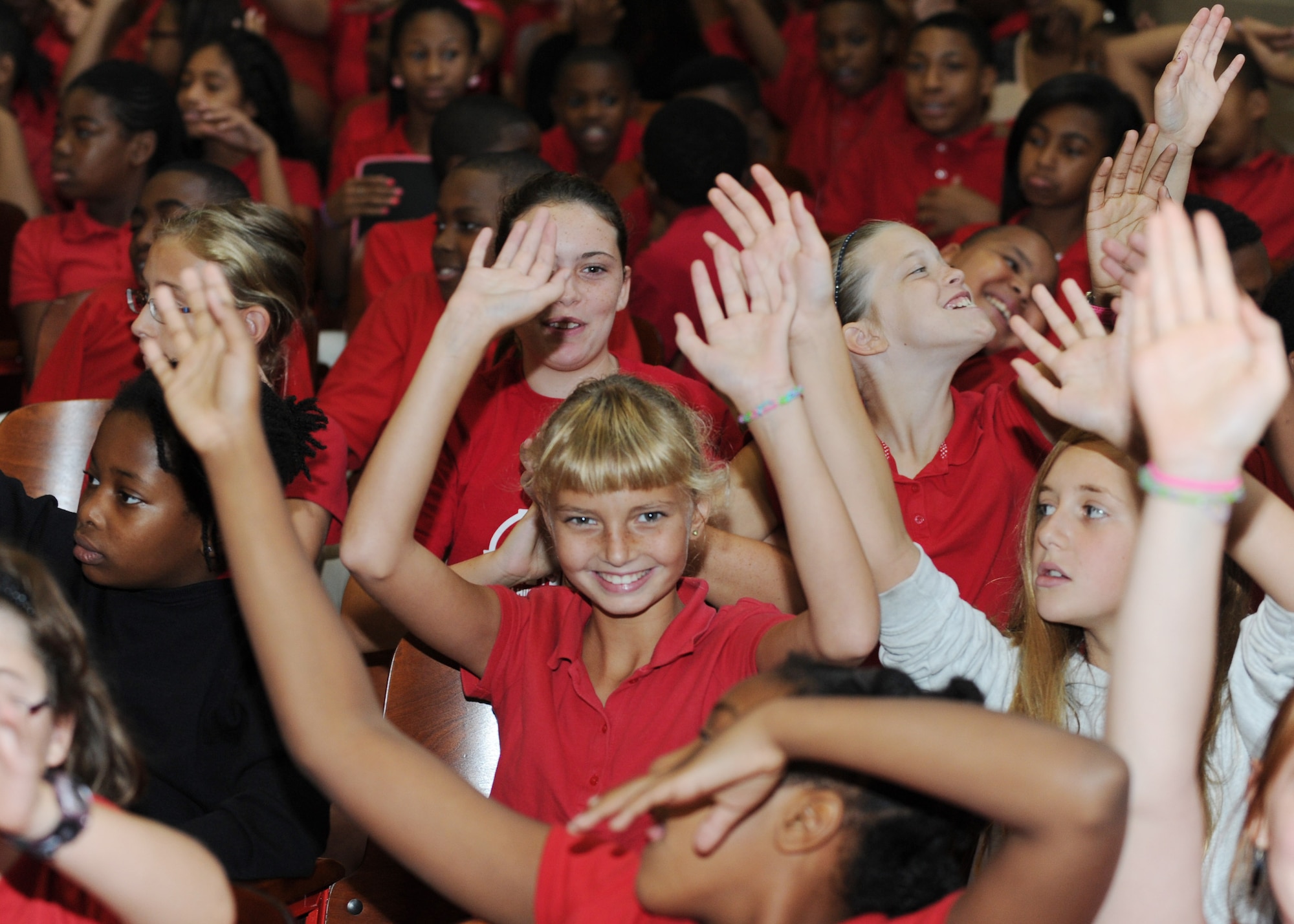 Penelope O’Donnell waves her arms during a concert at Stuart-Hobson Middle School, Washington, D.C., Sept. 11, 2013. Max Impact, the premier rock band of the United States Air Force, performed at the school as a part of the Advancing Innovation through Music program. (U.S. Air Force photo/Airman 1st Class Aaron Stout)