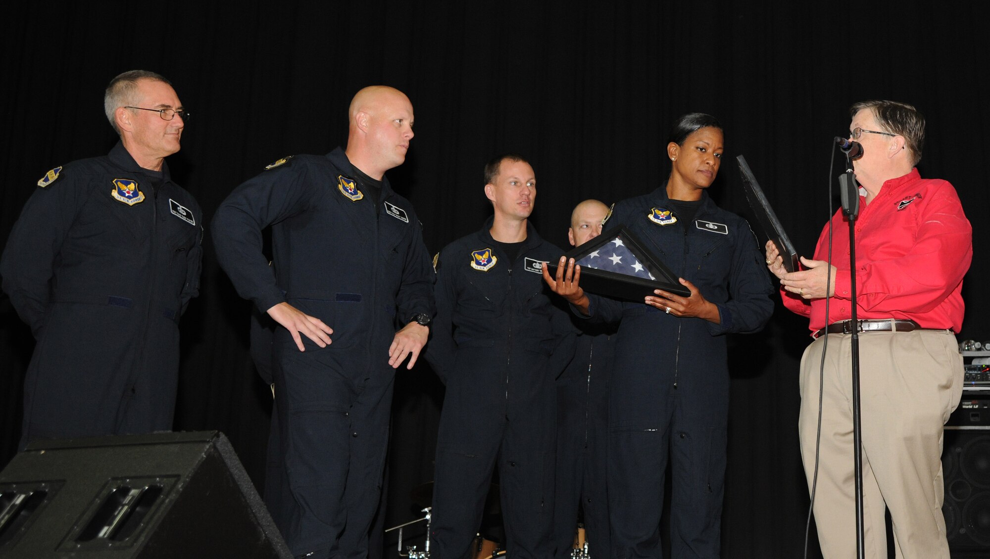 James Edwards presents a flag to Max Impact for their performance at Stuart-Hobson Middle School, Washington, D.C., Sept. 11, 2013. Max Impact, the premier rock band of the United States Air Force, performed at the school as a part of the Advancing Innovation through Music program. The flag was flown at the Pentagon Memorial dedication. (U.S. Air Force photo/Airman 1st Class Aaron Stout)