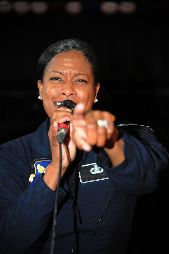 Master Sgt. Shani Prewitt performs for an auditorium of students at Stuart-Hobson Middle School, Washington, D.C., Sept. 11, 2013. Max Impact, the premier rock band of the United States Air Force, performed at the school as a part of the Advancing Innovation through Music program. Prewitt is the NCO in charge and vocalist with Max Impact, the United States Air Force Band. (U.S. Air Force photo/Airman 1st Class Aaron Stout)