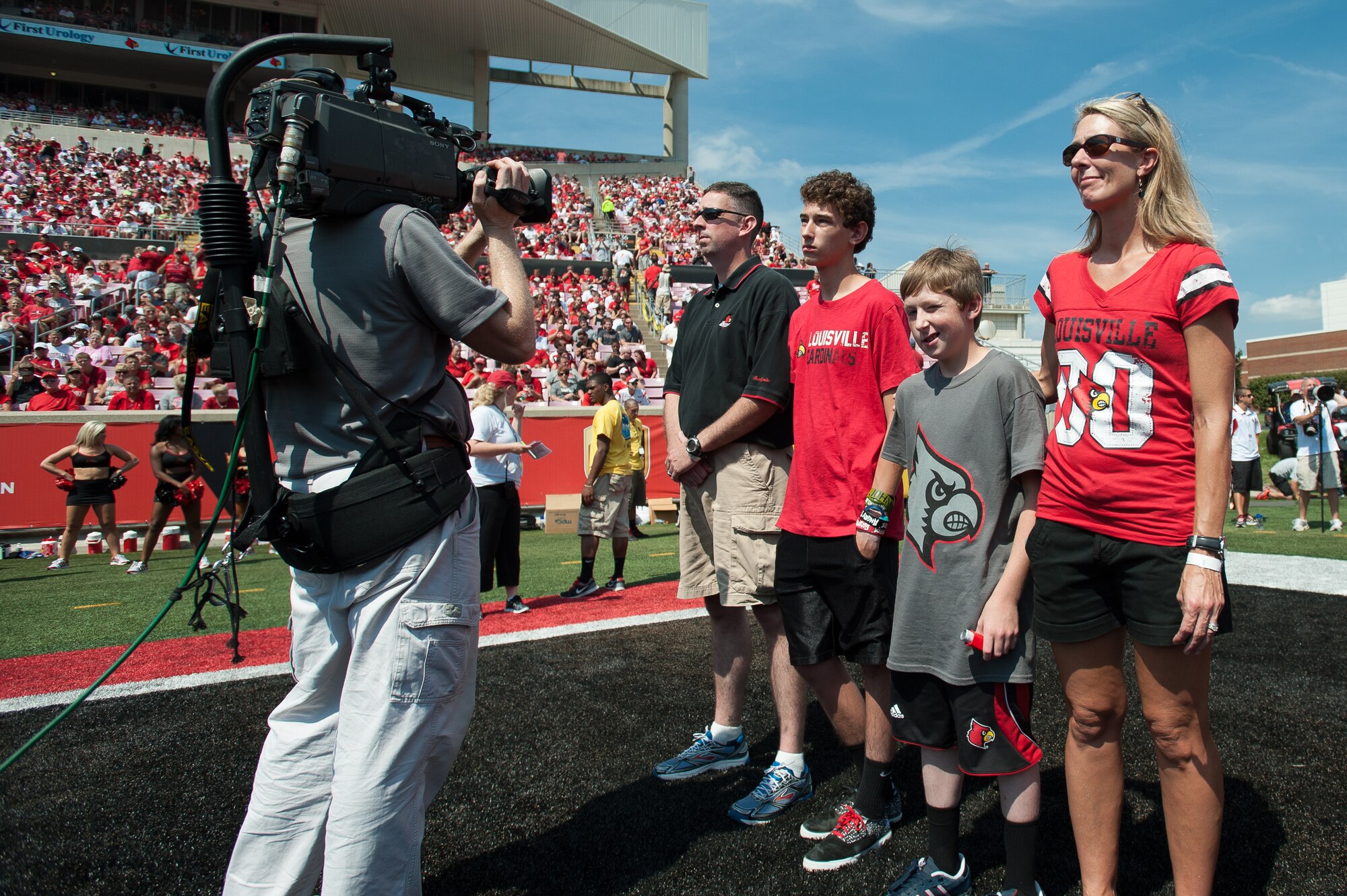 Lt. Col. Bruce Bancroft (left), a C-130 pilot and commander of the Kentucky Air National Guard’s 123rd Global Mobility Readiness Squadron, is honored for exceptional service Sept. 7, 2013, during Military Appreciation Day events held in conjunction with the University of Louisville-Eastern Kentucky University football game at Papa John’s Cardinal Stadium in Louisville, Ky. Bancroft has deployed multiple times in support of operations around the world, including four combat tours in Iraq and Afghanistan. (U.S. Air National Guard photo by Maj. Dale Greer)