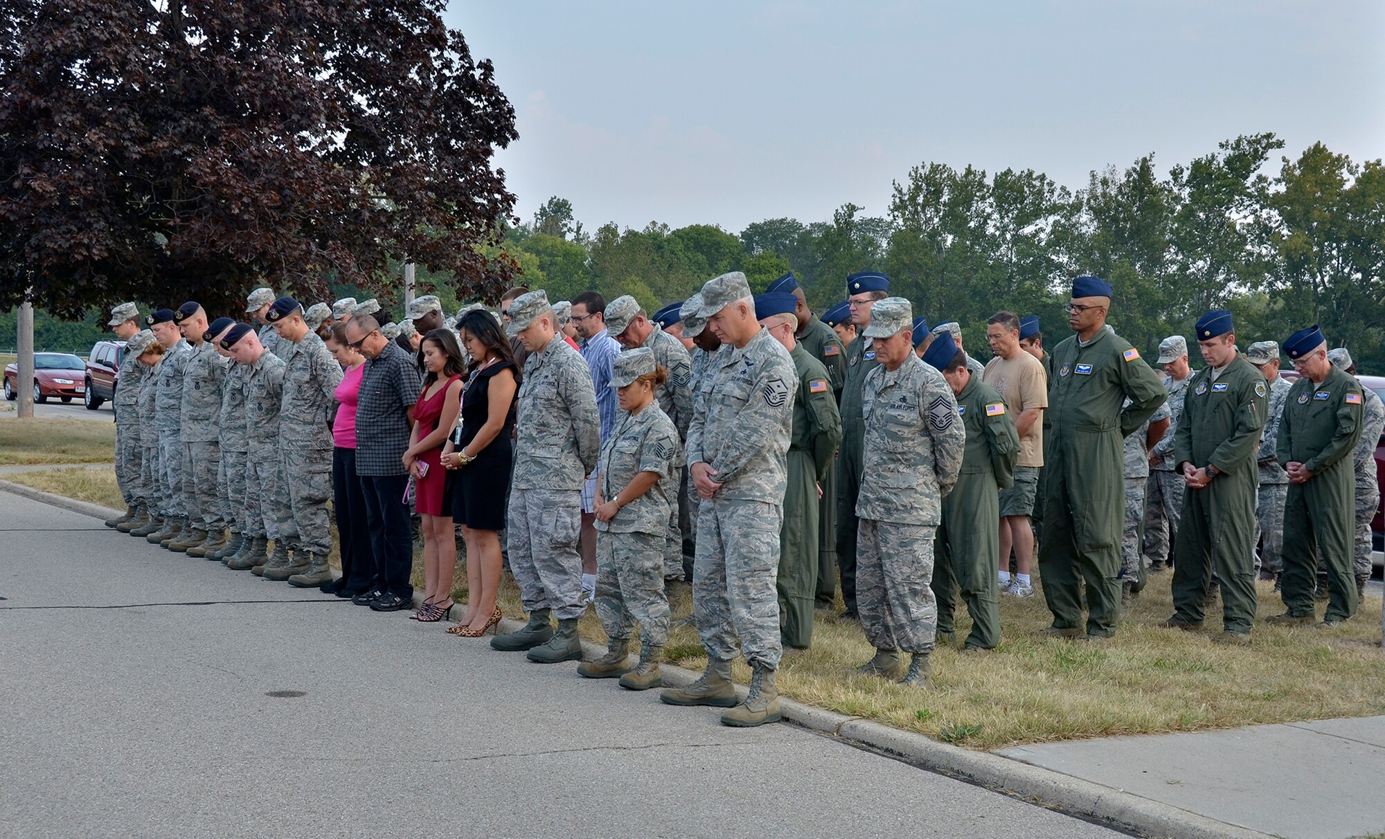 WRIGHT-PATTERSON AIR FORCE BASE, Ohio – The men and women of the 445th Airlift Wing pause for a moment of silence during the wing’s Patriot Day ceremony in front of the 445 AW Headquarters building Sept. 11, 2013. This year marks the twelfth year anniversary of the attacks. (U.S. Air Force photo/Stacy Vaughn)