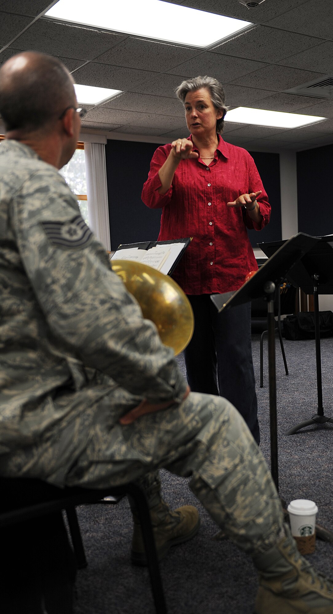 Felicia Foland gives Tech. Sgt. Clay Toms a different perspective on timing at the U.S. Band of Mid-America Freedom Winds rehearsal room Sept. 5, 2013. Foland is a St. Louis Orchestra bassoonist and Toms is the Band of Mid-America French horn player. Foland spent two and a half hours of her day coaching the Air Force band on how to perform to the best of their ability as a musician and as a team. (U.S. Air Force photo/Senior Airman Jake Eckhardt)