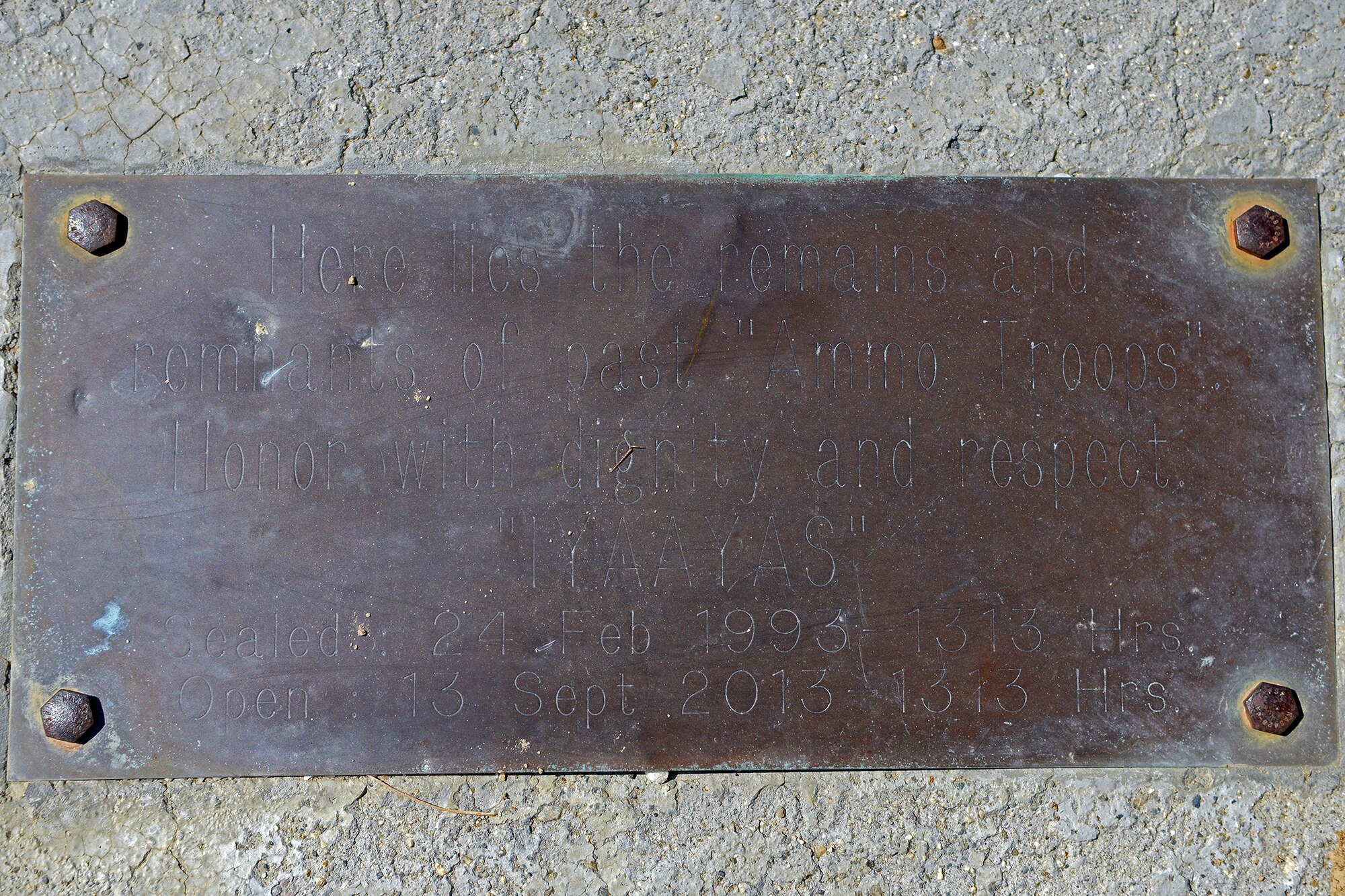 This is the original time capsule plaque created by munitions specialists with the then 6515th Munitions Maintenance Squadron. The time capsule was buried on Feb. 24, 1993 and unearthed Sep. 9, approximately 20 years later, by a few of the same personnel that were there to bury it. (U.S. Air Force photo by Jet Fabara)
