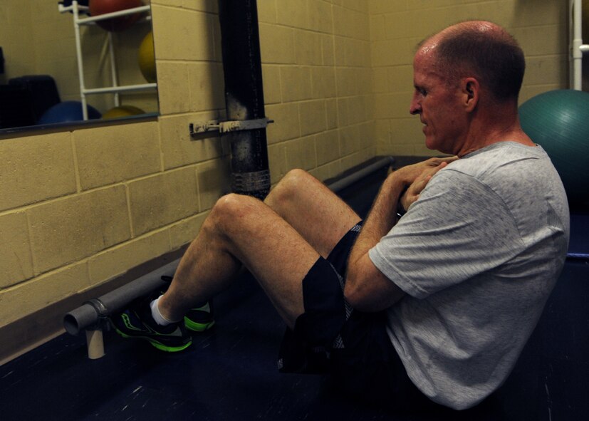 Maj. Gen. Stephen Wilson, 8th Air Force commander, performs sit-ups as a part of the Air Force physical training and Iron Airman tests at the Senior Bryan Bell Fitness Center on Barksdale Air Force Base, La., Sept. 9, 2013. The Iron Airman test allows Airmen an extra minute to do more sit-ups and push-ups. (U.S. Air Force photo/Senior Airman Joseph A. Pagán Jr.)