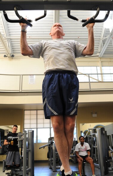 Maj. Gen. Stephen Wilson, 8th Air Force commander, performs pull-ups inside the Senior Airman Bryan Bell Fitness Center on Barksdale Air Force Base, La., Sept. 9, 2013. In conjunction to the Air Force physical training test, Wilson took the Iron Airman test which involves pull-ups, a two mile run, and two minutes of sit-ups and push-ups. (U.S. Air Force photo/Senior Airman Joseph A. Pagán Jr.)