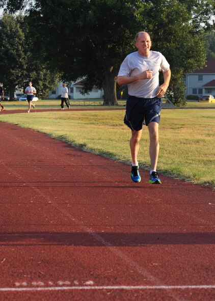Maj. Gen. Stephen Wilson, 8th Air Force commander, runs around the track at the Senior Airman Bryan Bell Fitness Center on Barksdale Air Force Base, La., Sept. 9, 2013. Wilson, with a total time of 13:38, not only passed his physical training test two and a half minutes sooner, but also ran an additional half-mile to complete and pass the Iron Airman test. (U.S. Air Force photo/Senior Airman Joseph A. Pagán Jr.)