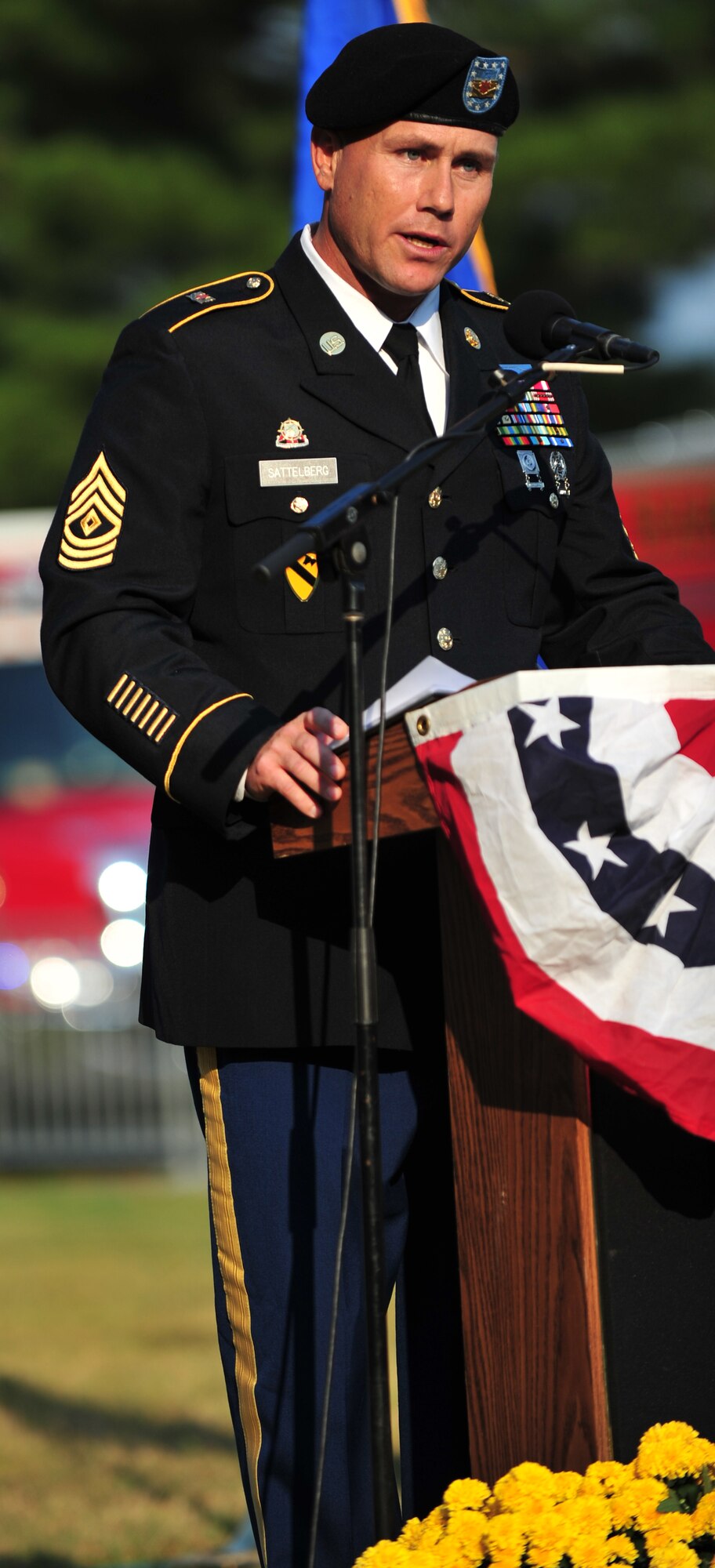 U.S. Army 1st Sgt. Ryan Sattelberg, from the 149th Seaport Operations Company, 10th Transportation Battalion, 7th Sustainment Brigade, speaks about his experiences surrounding the 9/11 attacks, during a remembrance ceremony at Gosnold’s Hope Park, Va., Sept. 11, 2013. The ceremony is held annually to honor victims of 9/11, as well as Service members who have paid the ultimate sacrifice while defending their country. (U.S. Air Force photo by Staff Sgt. Jarad A. Denton/Released)