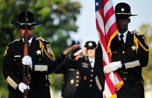 Police officers from the Hampton, Va. Sheriff’s Office rifle team prepare to present the American flag during a remembrance ceremony at Gosnold’s Hope Park, Sept. 11, 2013. The ceremony paid respects to the victims of the Sept. 11 terrorist attacks. (U.S. Air Force photo by Staff Sgt. Jarad A. Denton/Released)