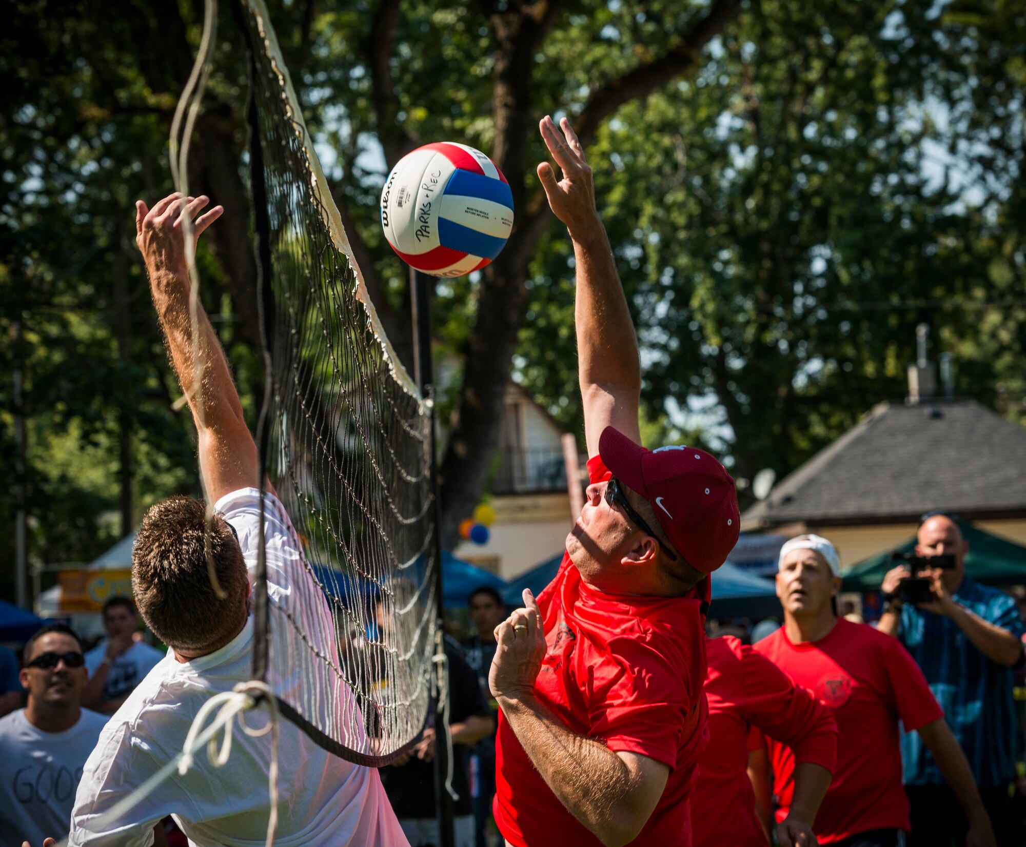 The Gunfighter Commanders (right) and Mayor's City Slickers volleyball teams play against each other during the 53rd annual Air Force Appreciation Days in Mountain Home, Idaho, Sept. 7, 2013. The Gunfighter Commanders beat the Mayor's City Slickers two games to one. (U.S. Air Force photo by Tech. Sgt. Samuel Morse/Released)