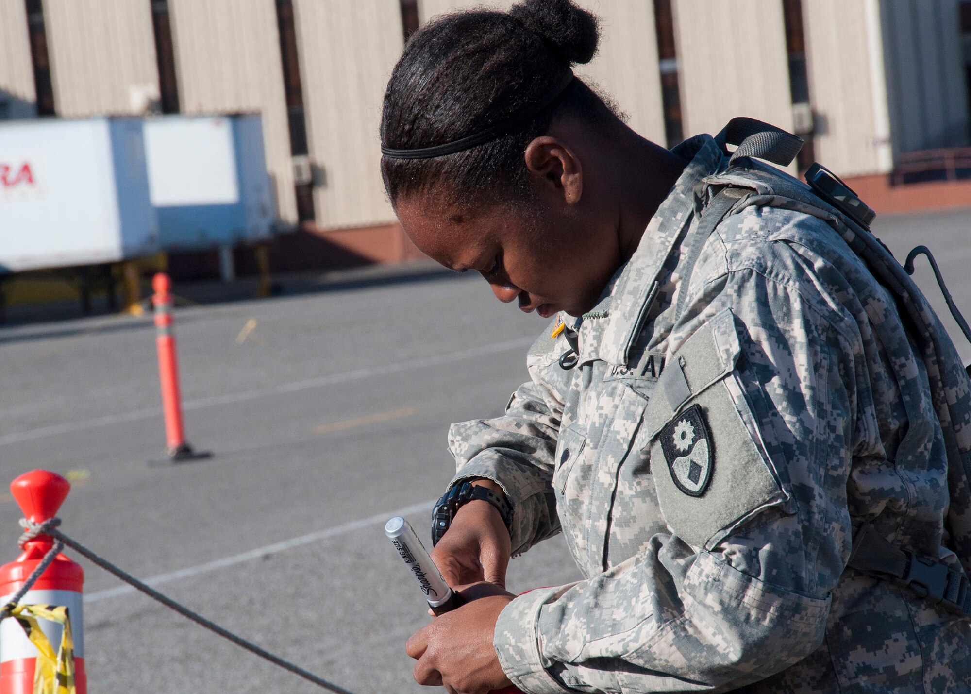 TRAVIS AIR FORCE BASE, Calif. -- Specialist Latoya Wadsworth, 149th Chemical Company, prepares cargo to be loaded on Air Force Aircraft during a joint training excercise on Sept. 7, 2013 at Travis Air force Base, Calif.  The 349th Air Mobility Wing's weekend-long specialty skills training event engaged more than 500 Reserve Airmen in hands-on training in the wing's core missions of moving passengers and cargo, generating sorties, flying aircraft, defending the base and providing high-quality medical care. This cost-saving training event fostered communication between units and enhanced esprit de corps. (U.S. Air Force photo/ Senior Airmen Amelia Leonard) 