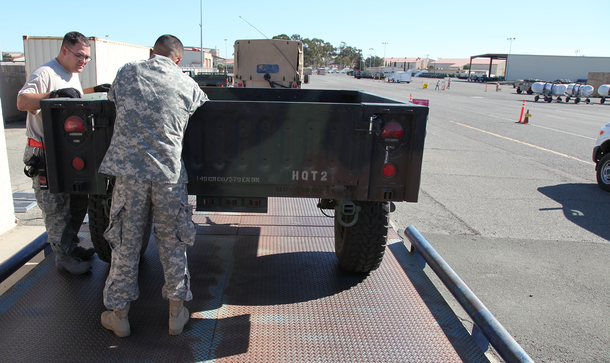 TRAVIS AIR FORCE BASE, Calif. -- Aerial Porters perform a joint inspection on California Army National Guard equipment and vehicles at Travis Air Force Base, Calif., Sept. 7, 2013. The joint inspection process ensures cargo is safe and prepared for transport on Air Mobility Command aircraft. The Guardsmen from the 149th Chemical Company, 579th Engineer Battalion, Turlock, Calif., trained with Travis Air Force Reservists reinforce skills and interoperability. The 349th Air Mobility Wing's weekend-long specialty skills training event engaged more than 500 Reserve Airmen in hands-on training in the wing's core missions of moving passengers and cargo, generating sorties, flying aircraft, defending the base and providing high-quality medical care. This cost-saving training event fostered communication between units and enhanced esprit de corps.  (U.S. Air Force Photo / Lt. Col. Robert Couse-Baker)