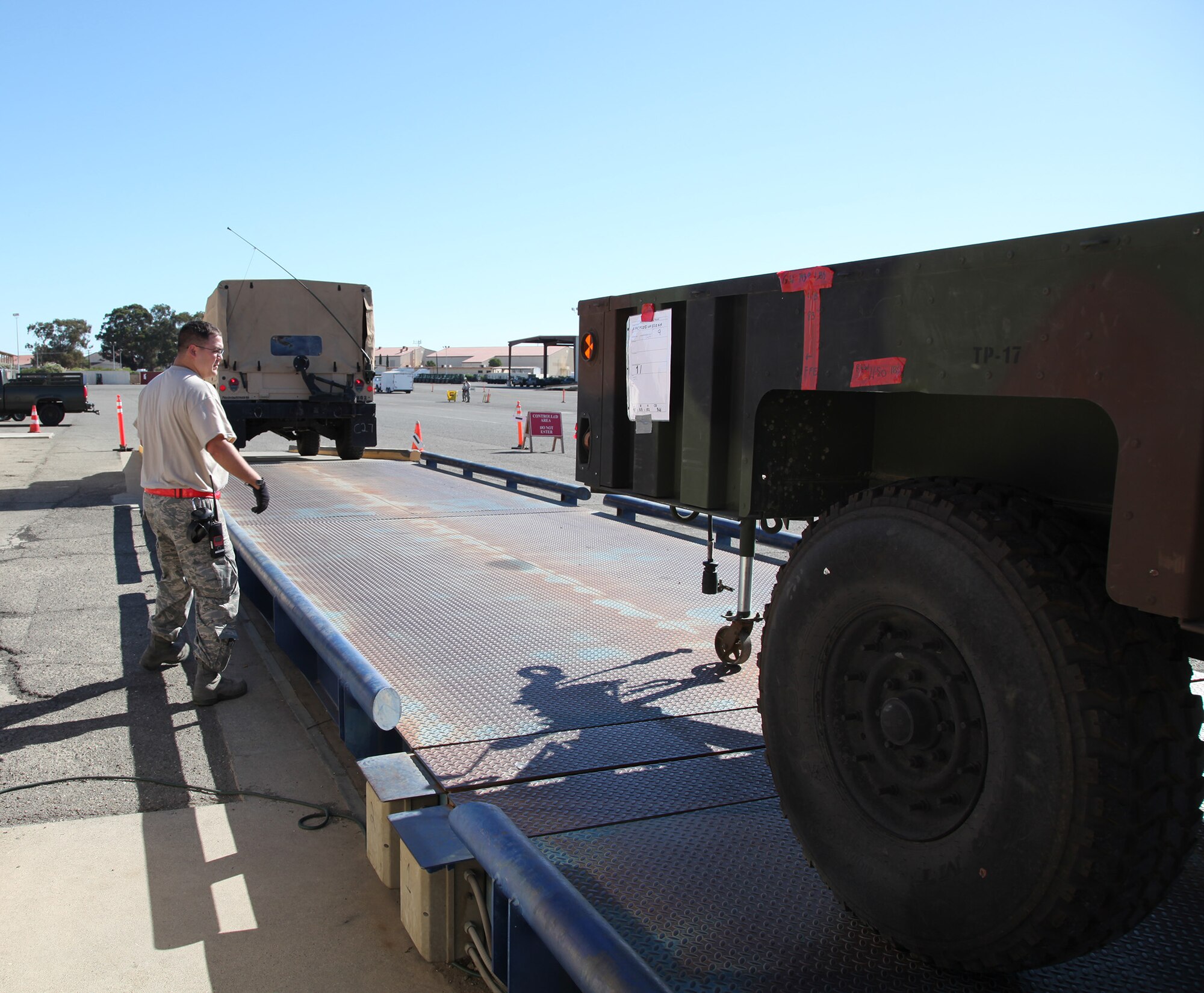 TRAVIS AIR FORCE BASE, Calif. -- Aerial Porters perform a joint inspection on California Army National Guard equipment and vehicles at Travis Air Force Base, Calif., Sept. 7, 2013. The joint inspection process ensures cargo is safe and prepared for transport on Air Mobility Command aircraft. The Guardsmen from the 149th Chemical Company, 579th Engineer Battalion, Turlock, Calif., trained with Travis Air Force Reservists reinforce skills and interoperability. The 349th Air Mobility Wing's weekend-long specialty skills training event engaged more than 500 Reserve Airmen in hands-on training in the wing's core missions of moving passengers and cargo, generating sorties, flying aircraft, defending the base and providing high-quality medical care. This cost-saving training event fostered communication between units and enhanced esprit de corps.  (U.S. Air Force Photo / Lt. Col. Robert Couse-Baker)