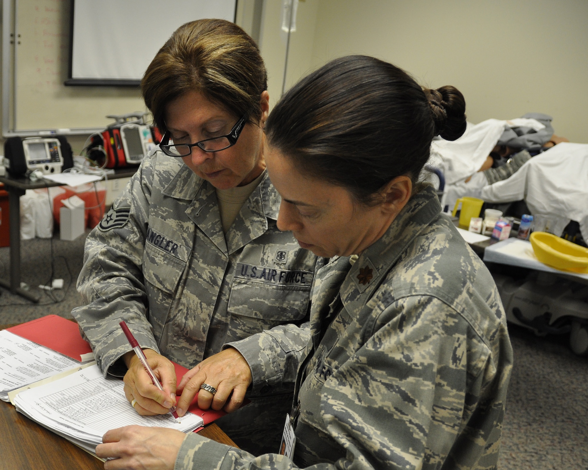 TRAVIS AIR FORCE BASE, Calif. -- Members of the 349th Aeromedical Staging Squadron practice medical procedures in the 60th Medical Group's Simulation Center at the David Grant USAF Medical Center Sept. 7, 2013.  The 349th Air Mobility Wing's weekend-long specialty skills training event engaged more than 500 Reserve Airmen in hands-on training in the wing's core missions of moving passengers and cargo, generating sorties, flying aircraft, defending the base and providing high-quality medical care. This cost-saving training event fostered communication between units and enhanced esprit de corps.  (U.S. Air Force Photo / Lt. Col. Robert Couse-Baker)