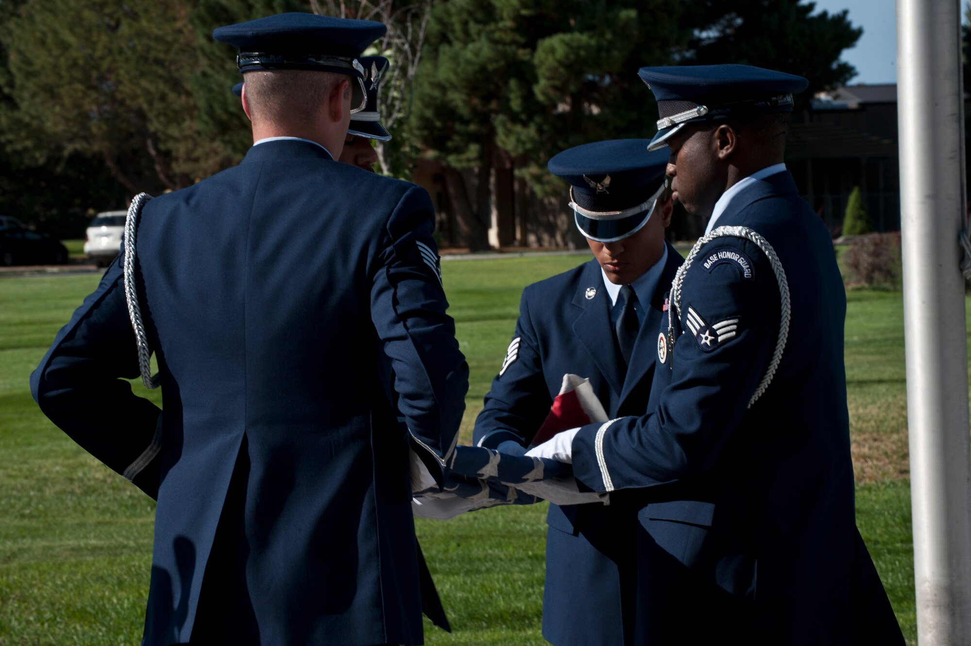 Mountain Home Air Force Base Honor Guardsmen fold the American flag Sep. 5, 2013, during an Air Force Appreciation Day retreat ceremony at Holt Park in MHAFB, Idaho. A retreat ceremony not only signals the end of the duty day but pays respect to the American flag. (U.S. Air Force photo by Staff Sgt Roy Lynch/Released)