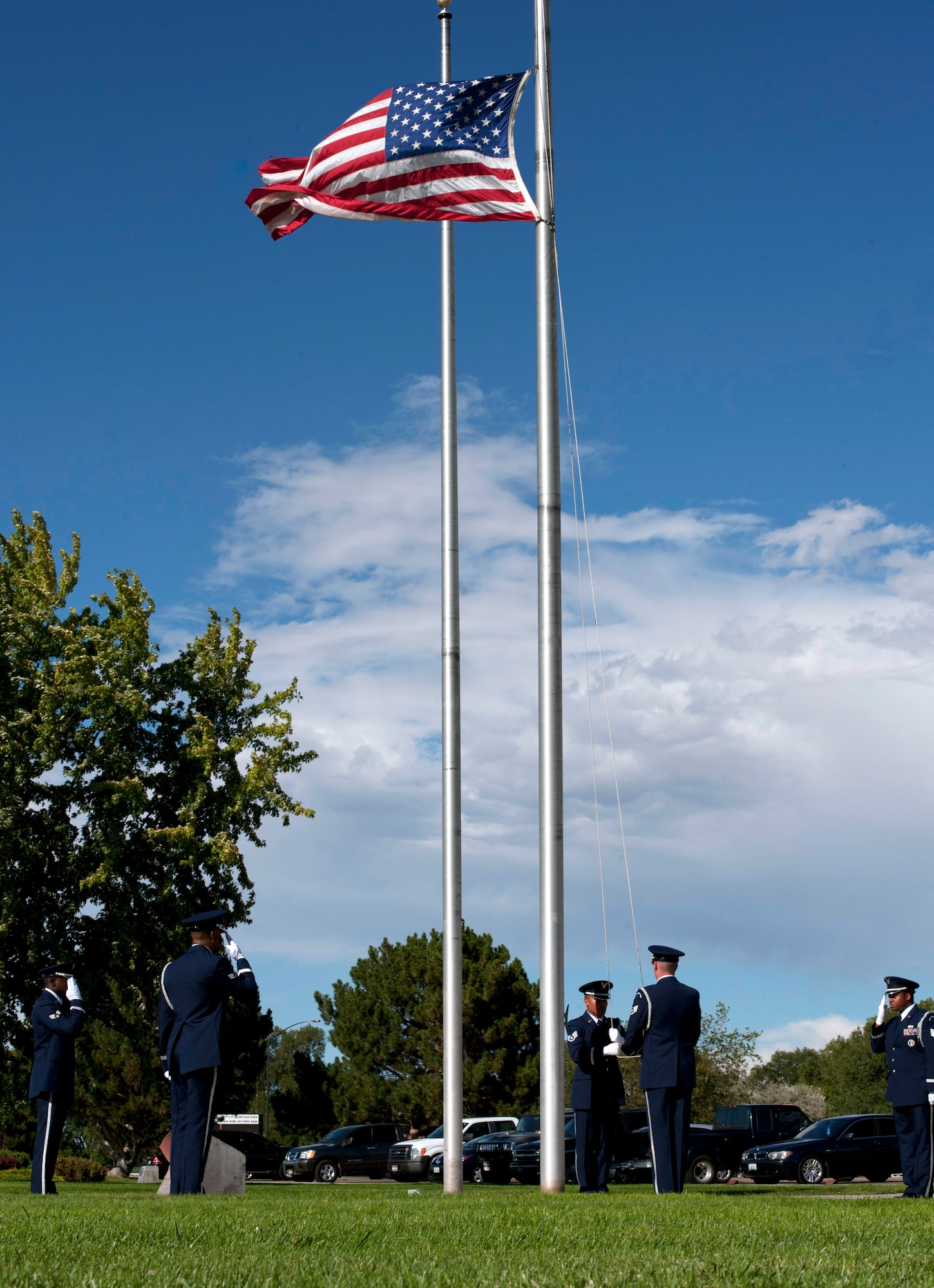 Mountain Home Air Force Base Honor Guardsmen lower the American flag Sep. 5, 2013, during an Air Force Appreciation Day retreat ceremony at Holt Park on MHAFB, Idaho. This year marks the 53rd annual AFAD to thank military personnel for their dedication and sacrifice for this country. (U.S. Air Force photo by Staff Sgt Roy Lynch/Released)