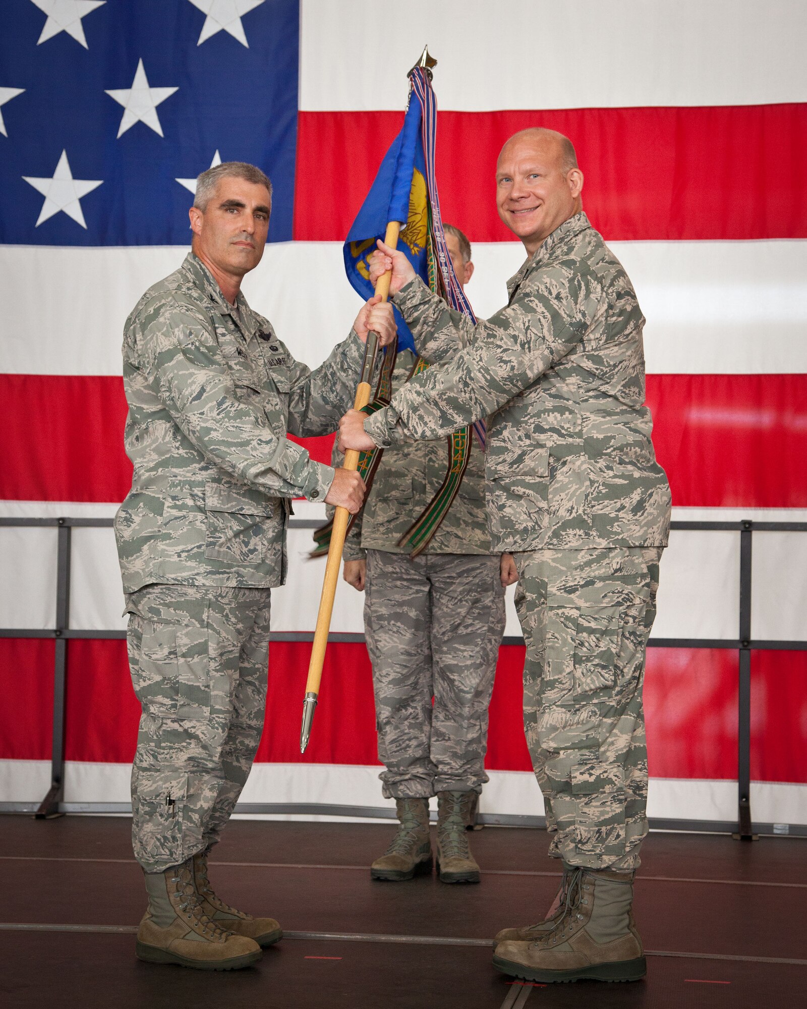 Col. Keith Wesley, 934th Operations Group commander, passes the guidon to Lt. Col. Peter Draheim, 934th Operations Support Squadron commander.  Col. Wesley presided over the change of command ceremony, during which Lt. Col. Robert Hockman reliquished command of the squadron to Lt. Col. Draheim.  (U.S. Air Force photo/Shannon McKay)