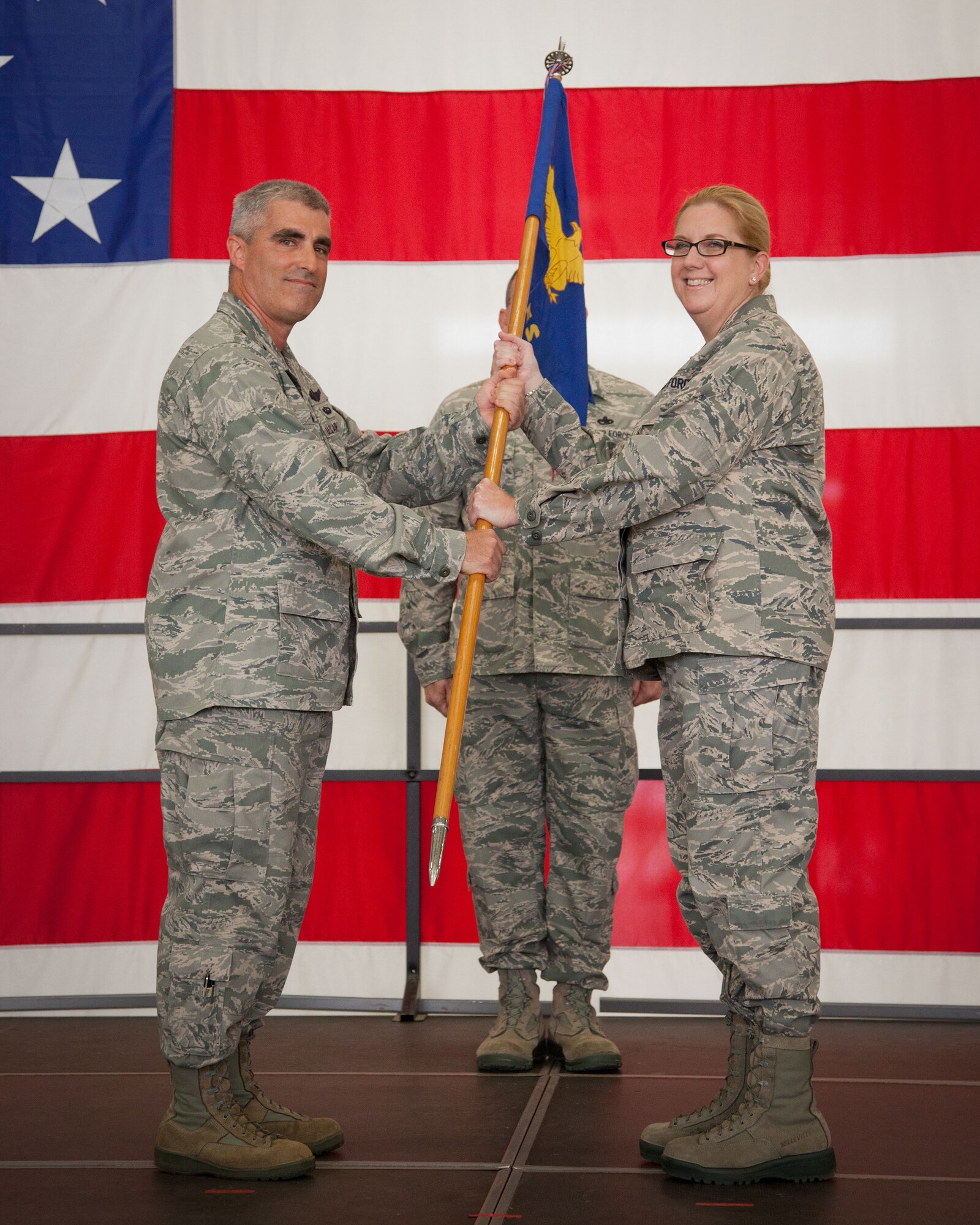 Col. Keith Wesley, 934th Operations Group commander, presents Lt. Col. Bonnie Bosler, 934th Aeromedical Evacuation Squadron commander, with the squadron guidon.  Lt. Col. Bosler assumes command of the 934 AES during the September Unit Training Assembly weekend at the Minneapolis-St. Paul Air Reserve Station, Minn.  (U.S. Air Force photo/Shannon McKay)