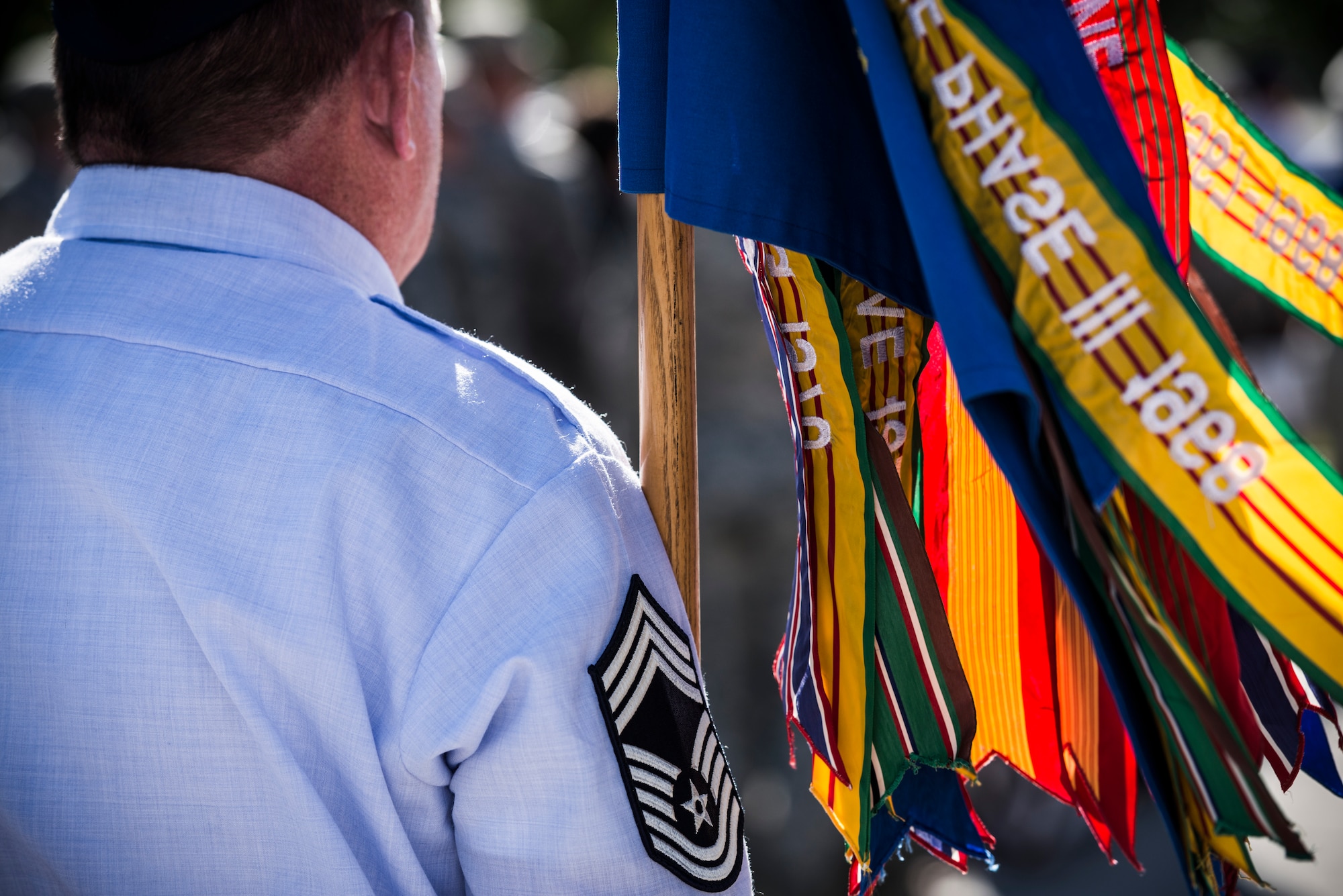 U.S. Air Force Chief Master Sgt. Brian Pollreis, 366th Maintenance Group superintendent, holds the 366th Fighter Wing guidon during a wing retreat at Mountain Home Air Force Base, Idaho, Sept. 5, 2013. The guidon is adorned with numerous ribbons signifying awards the Wing has won in the past. (U.S. Air Force photo by Tech. Sgt. Samuel Morse/Released)