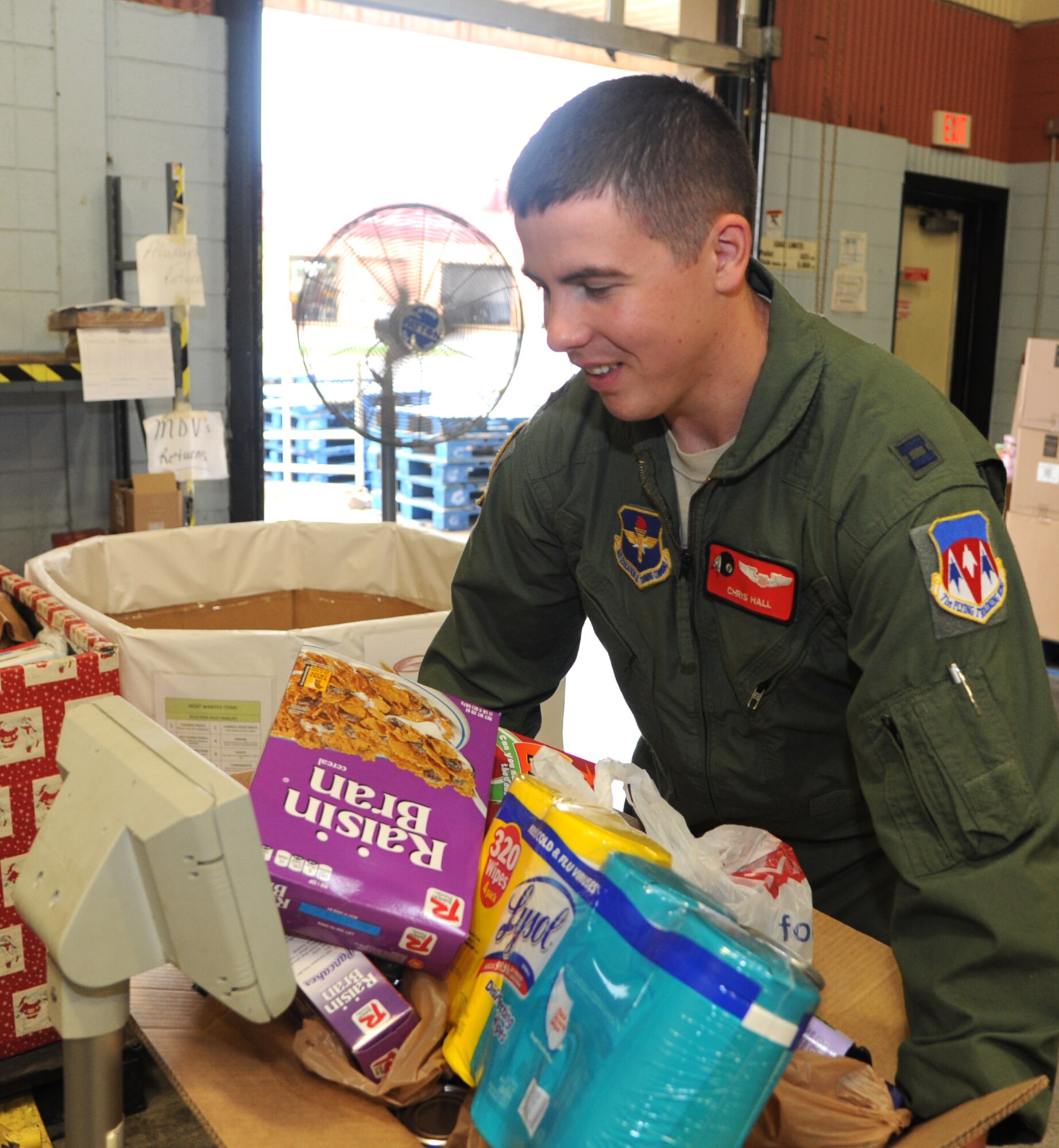 Capt. Chris Hall weighs and sorts some of the almost 4 tons of food Team Vance donated this year to a local food bank during the 2013 Feds Feed Families food drive. (U.S. Air Force photo/ Senior Airman Frank Casciotta)