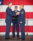 Maj. Jeff Gorman, 934th Aircraft Maintenance Squadron commander, presents Master Sgt. John Sadlovsky with his Meritorious Service Medal during his retirement ceremony at the Minneapolis-St. Paul Air Reserve Station, Minn.  (U.S. Air Force photo/Shannon McKay)