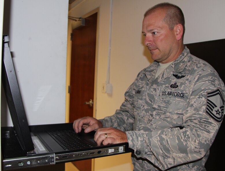 Senior Master Sgt. Don Fleming of the 932nd Airlift Wing Force Support Squadron performs routine maintenance on one of the wing's servers.  Fleming is one fo the Air Force Reserve Technicians that work at Scott Air Force Base during the week ensuring wing computers and technology are up and operational.  He has been a proud member of the 932nd AW for several years. (U.S. Air Force photo/Staff Sgt. Meiko Schill)