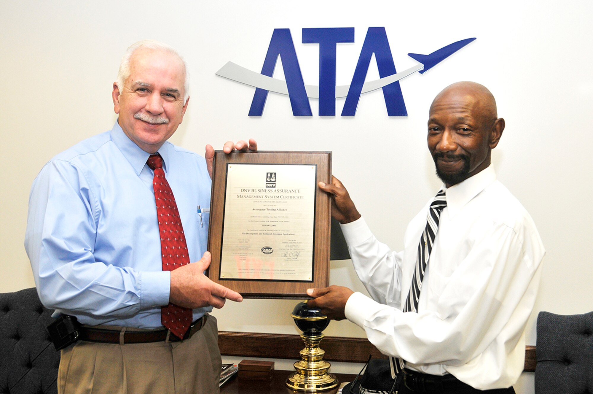 Aerospace Testing Alliance (ATA) General Manager Steve Pearson and J.T. Northcutt, an ATA quality manager and management system branch manager, display the recently received ISO 9001:2008 certificate plaque certifying that ATA has been found to conform to the Management System Standard. (Photo by Rick Goodfriend)