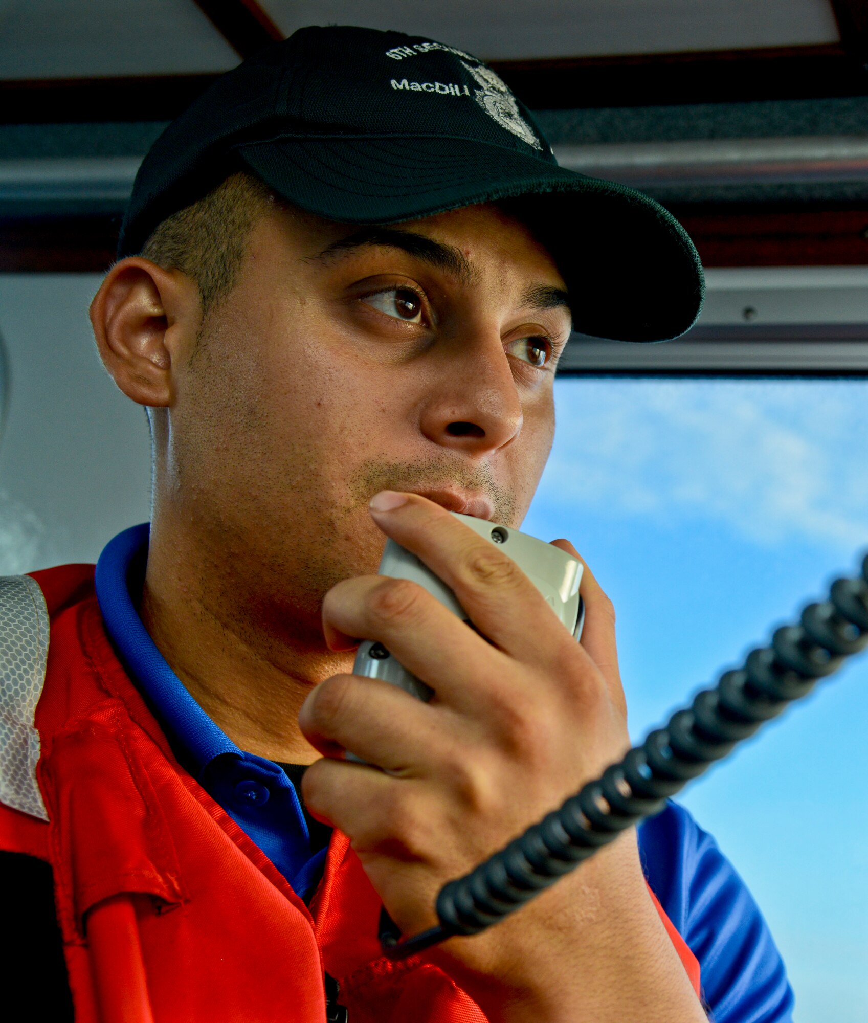 Senior Airman Luis Gonzalez, crew member with the 6th Security Forces Squadron marine patrol, calls in a report to the base defense operations center at MacDill Air Force Base, Fla., Sept. 5, 2013. 6th SFS marine patrol track the restricted waters around MacDill with cameras and radars. (U.S. Air Force photo by Airman 1st Class Ned T. Johnston/Released)