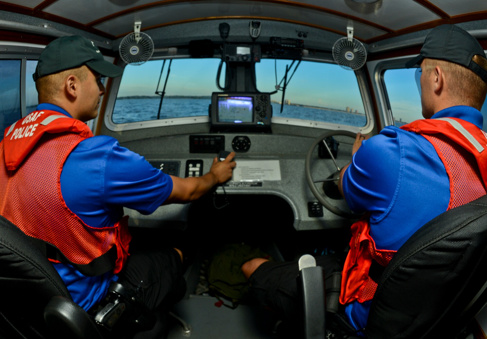 Senior Airman Luis Gonzalez and Senior Airman Cale Schumacher, 6th Security Forces Squadron marine patrolmen, patrol the waters around MacDill Air Force Base, Fla., Sept. 5, 2013. Gonzalez and Schumacher detect and deter any persons or vessels from entering  the restricted waters around MacDill. (U.S. Air Force photo by Airman 1st Class Ned T. Johnston/Released)